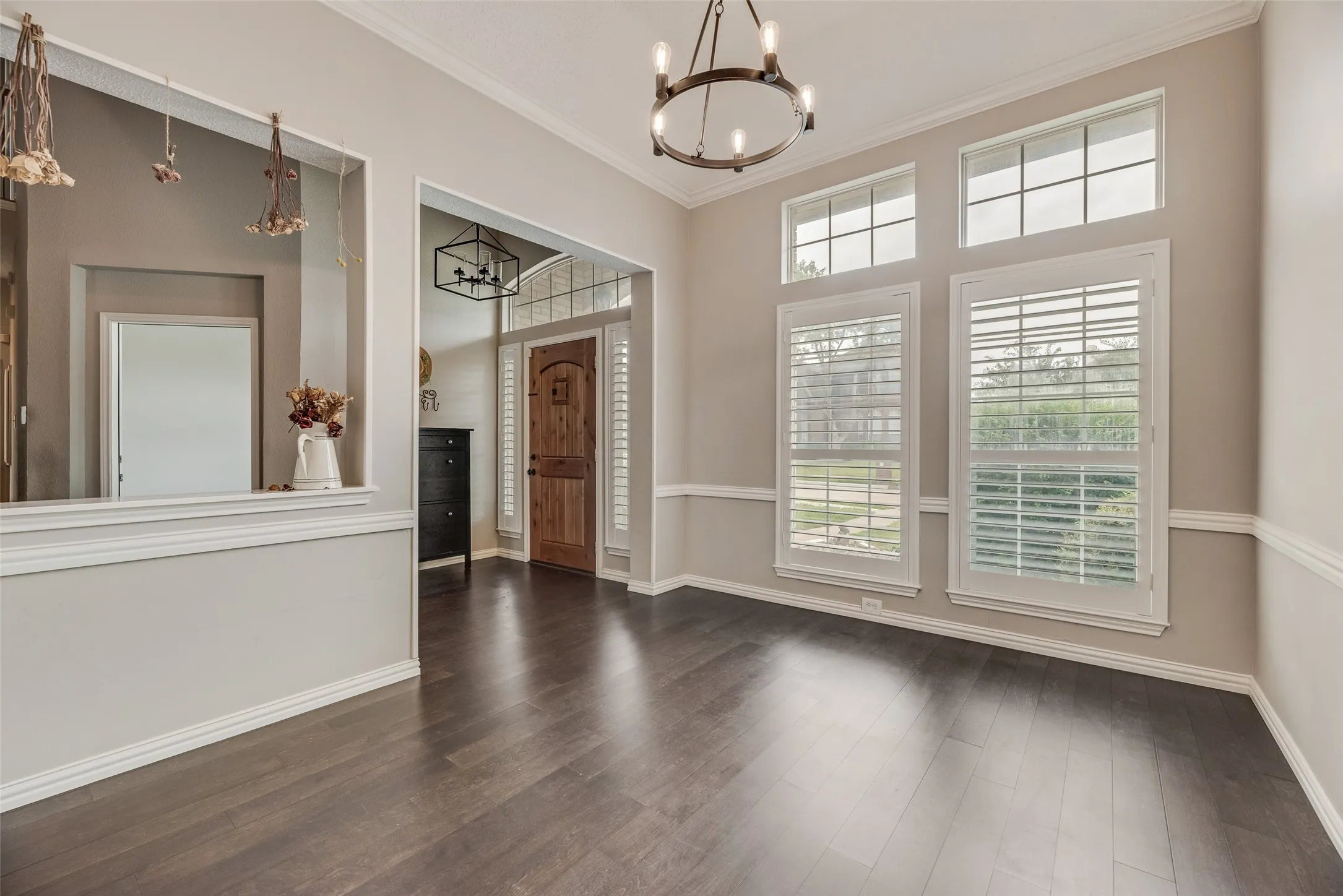 Wood-finish flooring throughout, framed by white crown molding