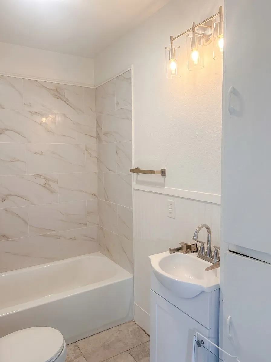 Tub and shower combination with large format tile surround