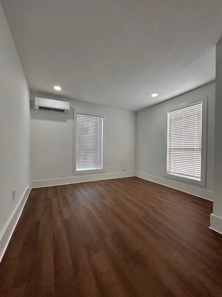 2nd bedroom with wood-finish flooring, recessed lighting, and multiple windows with blinds. Also has large closet.