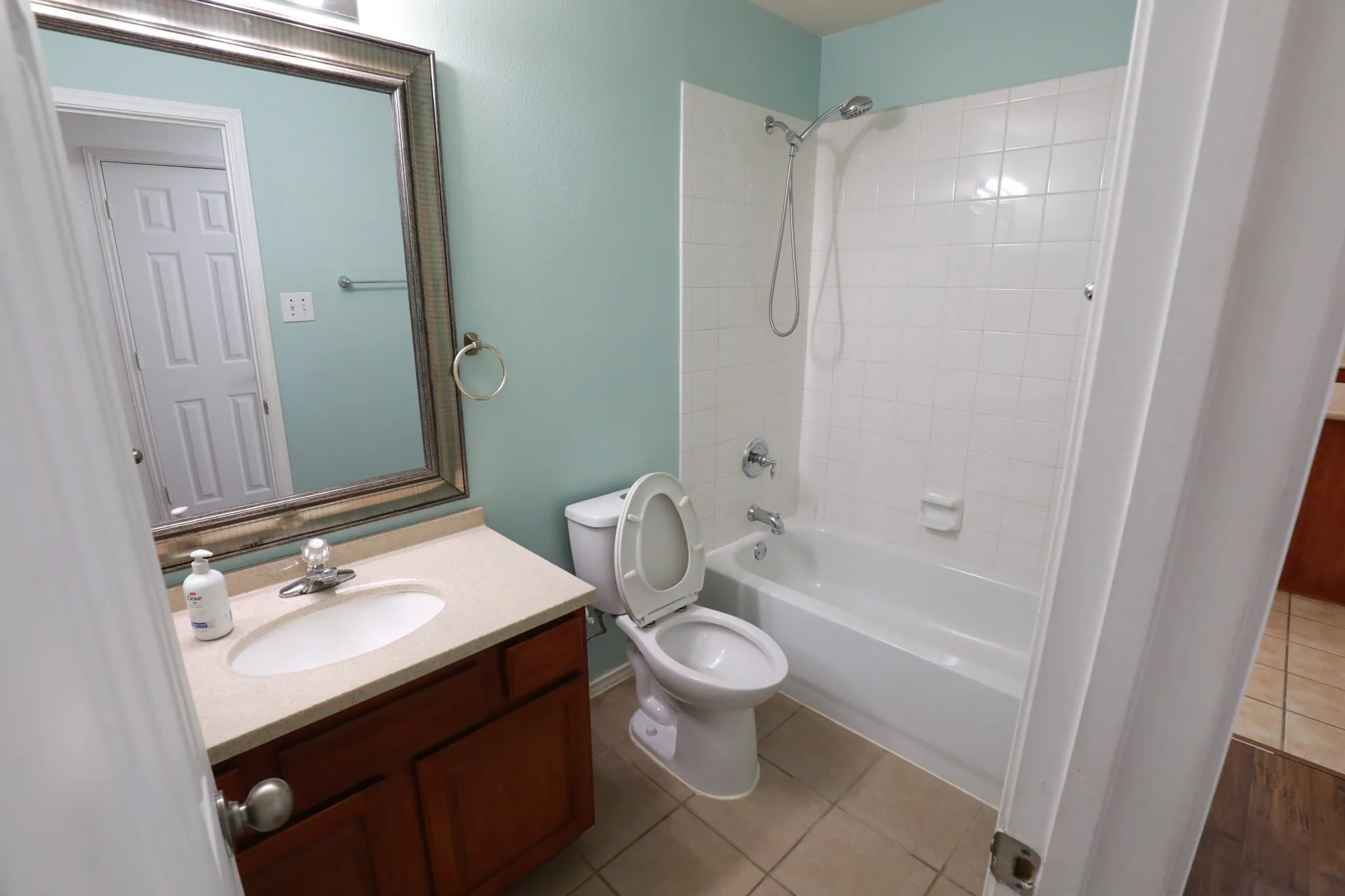 Bathroom featuring a vanity with a light-colored countertop, an undermount sink, and a wood-finish cabinet