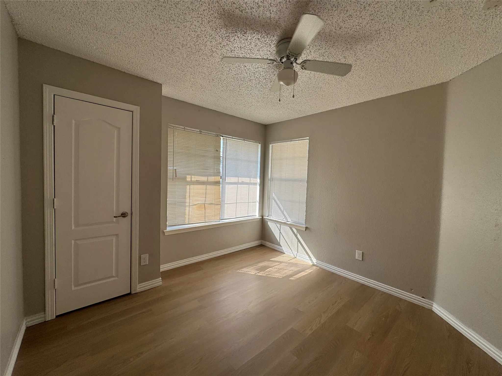 Wood-finish flooring with white baseboards
