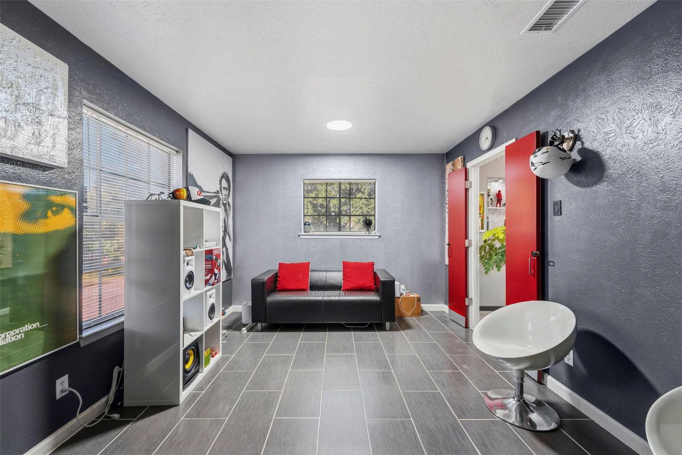 Tile flooring, dual windows with blinds, recessed ceiling lighting, and red double doors