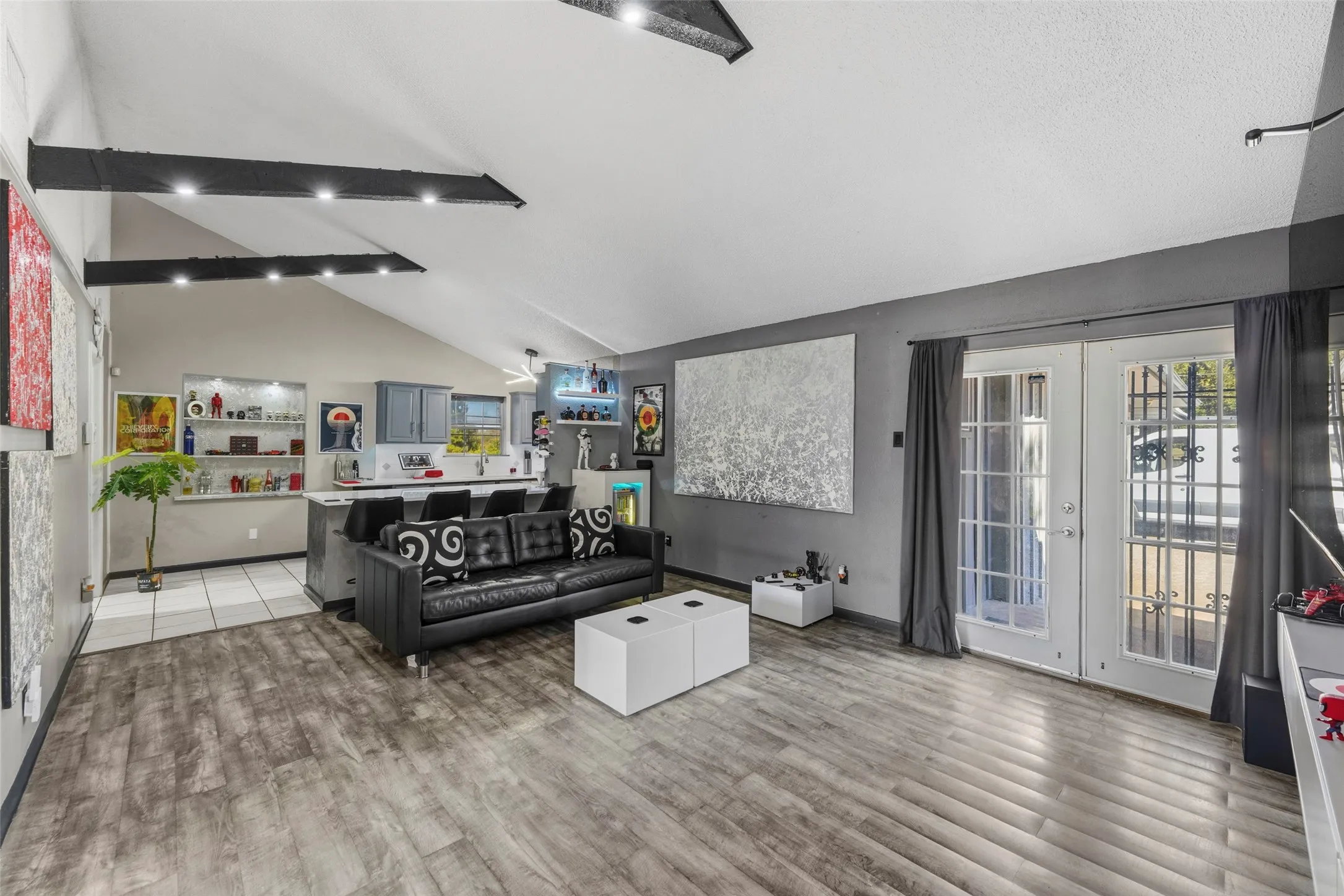 Vaulted ceiling with exposed beams and recessed lighting