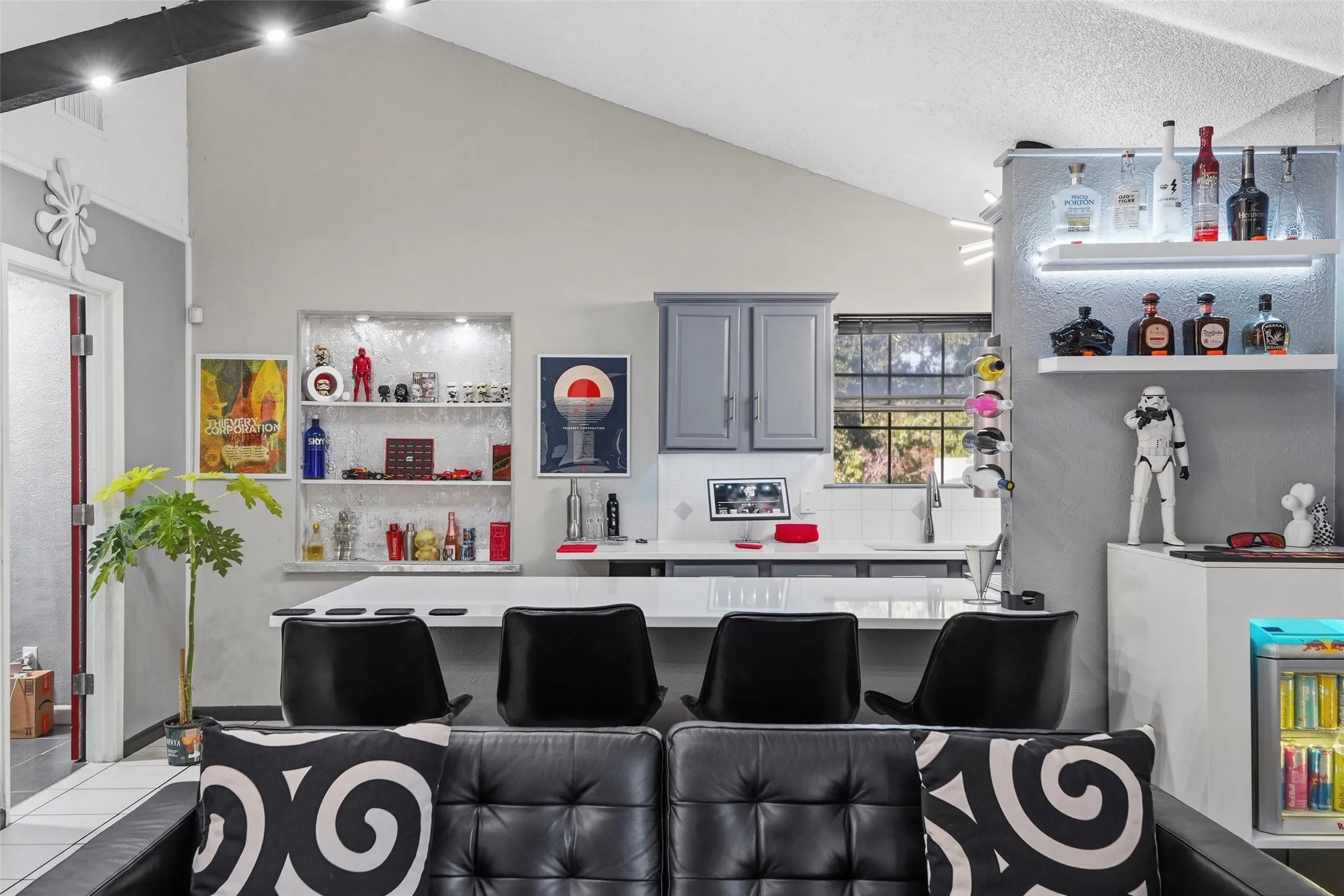 Kitchen features a white countertop, gray cabinetry, and a window with outdoor views