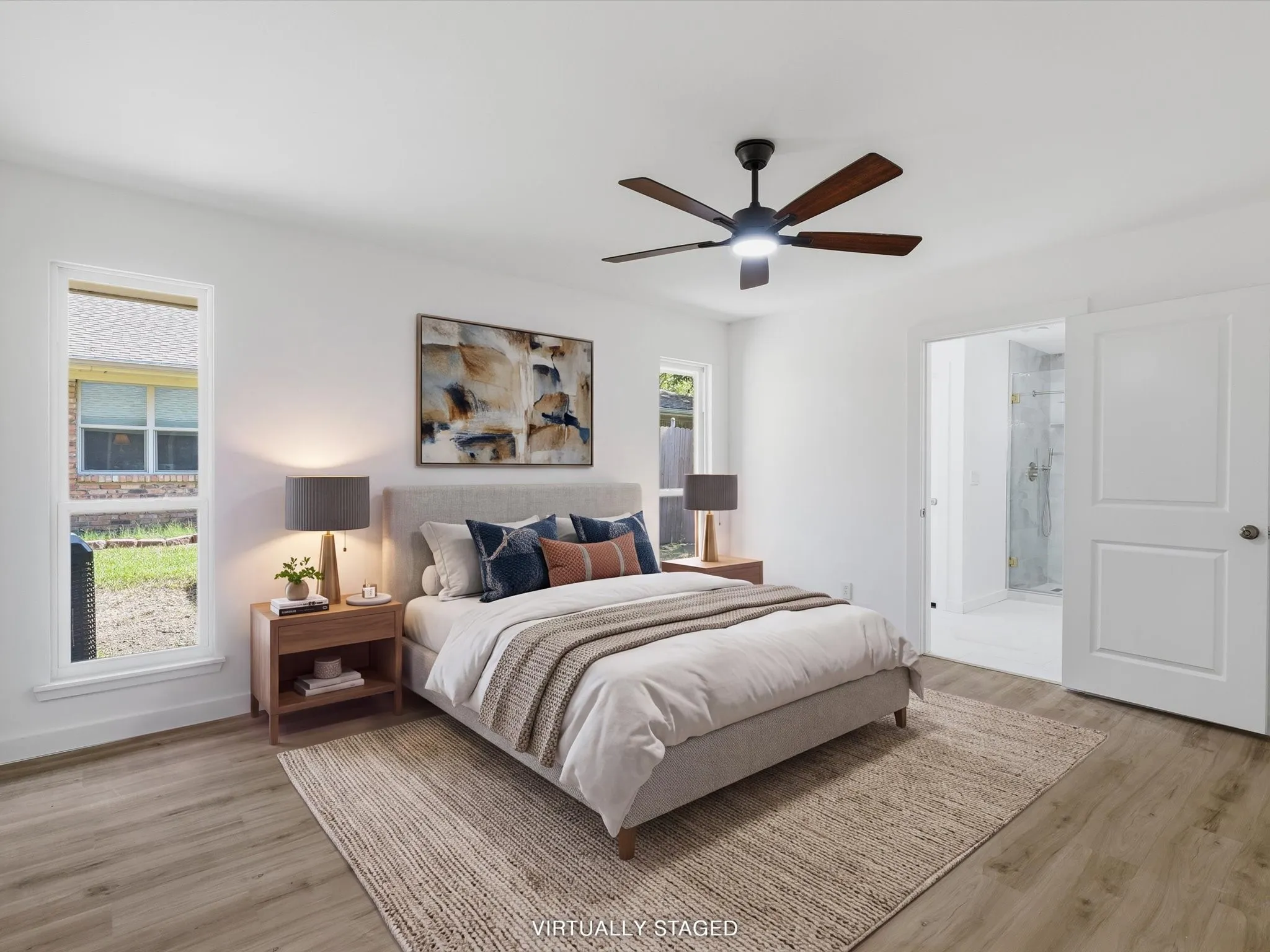 Wood-finish flooring, white walls, and a ceiling fan with integrated lighting