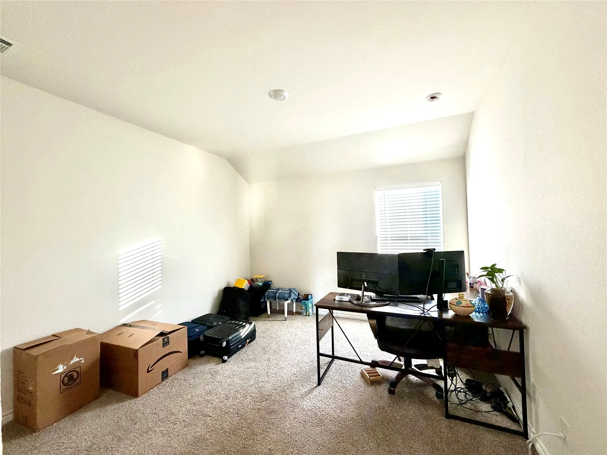 Recessed ceiling lighting, textured wall finish, window with horizontal blinds, and carpeting