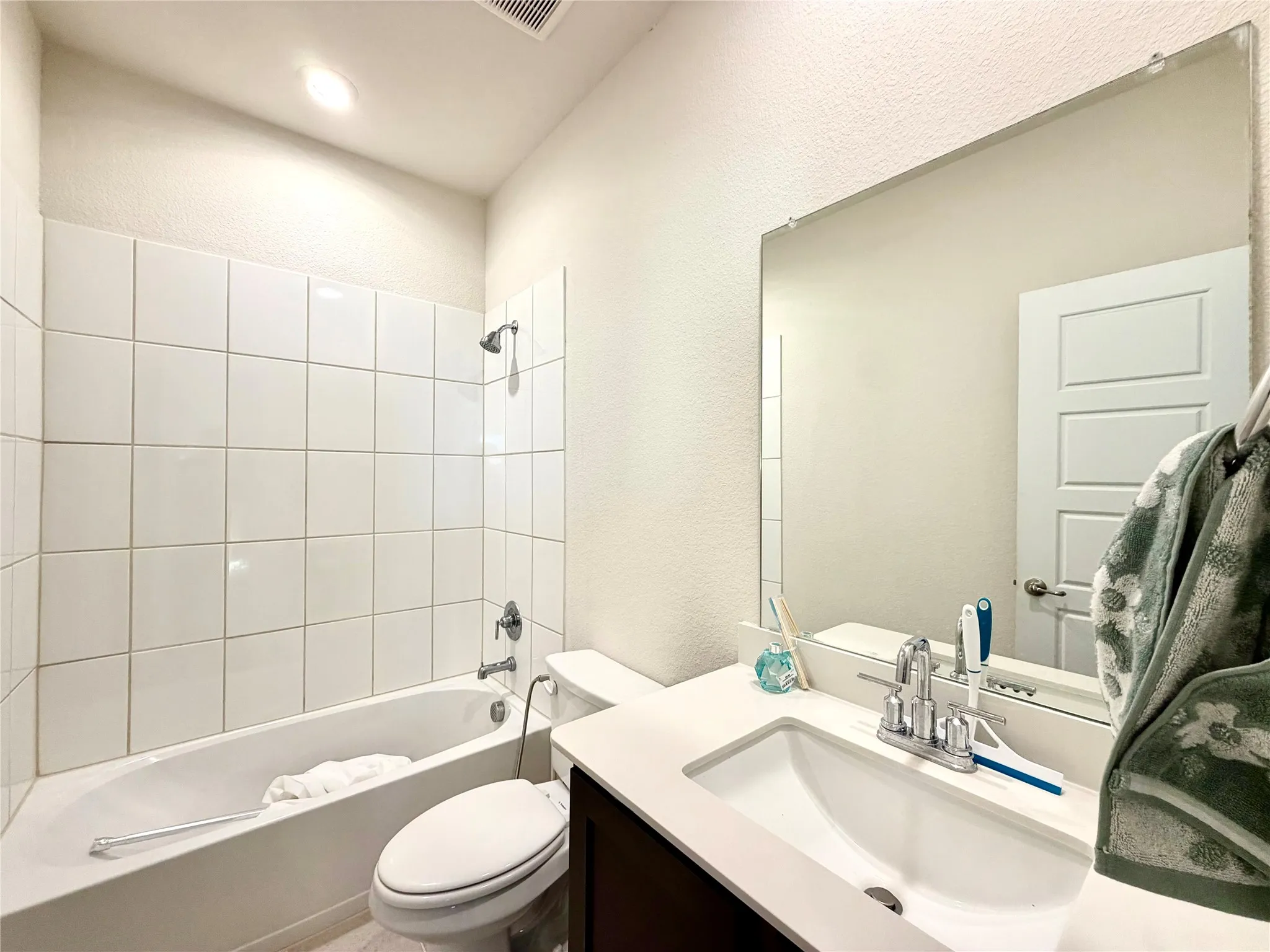 White tiled shower and tub combination