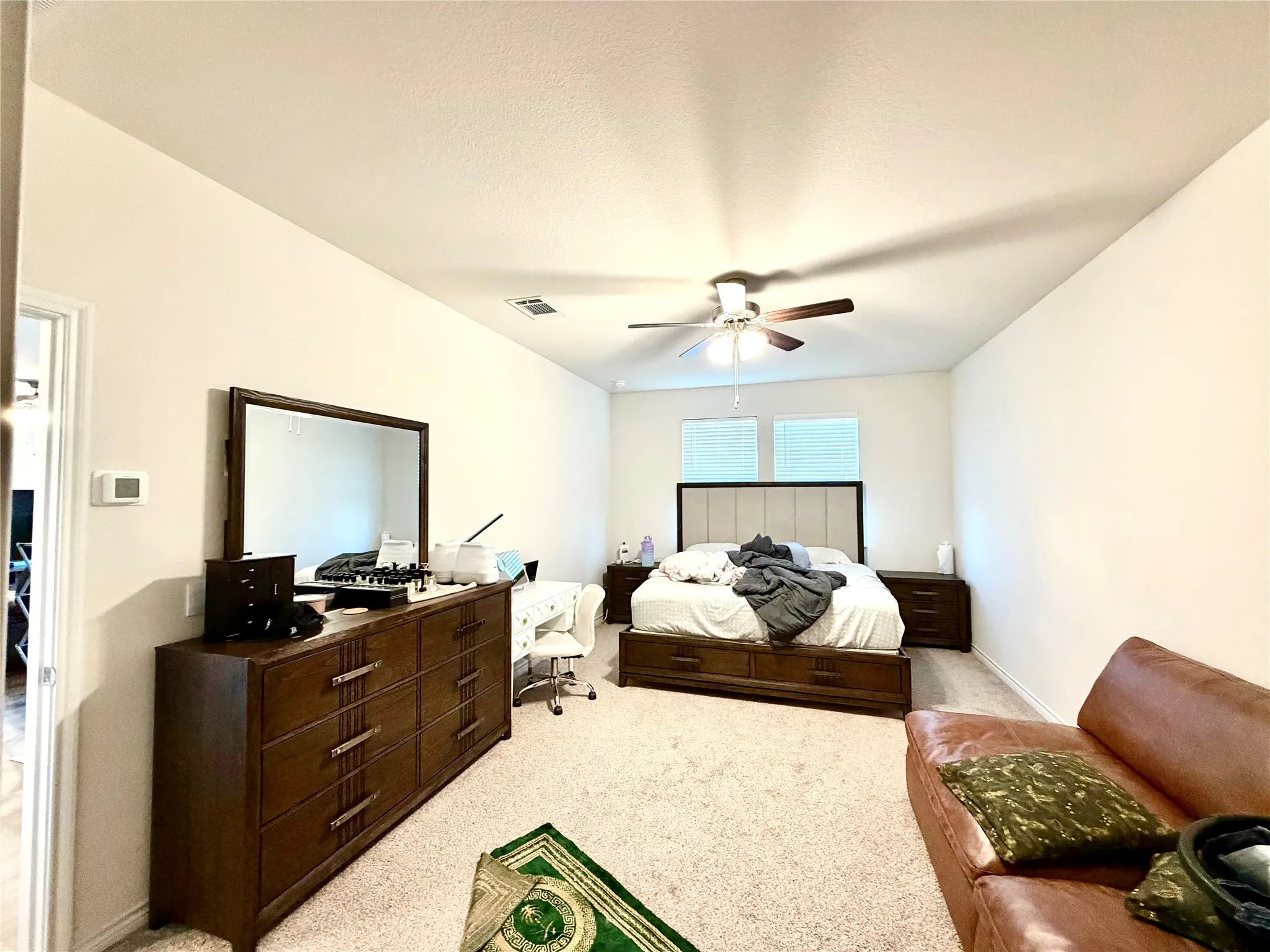 Carpeted flooring, white walls, and a ceiling fan with light​​‌​​​​‌​​‌‌​‌‌​​​‌‌​‌​‌​‌​​​‌​​ fixture