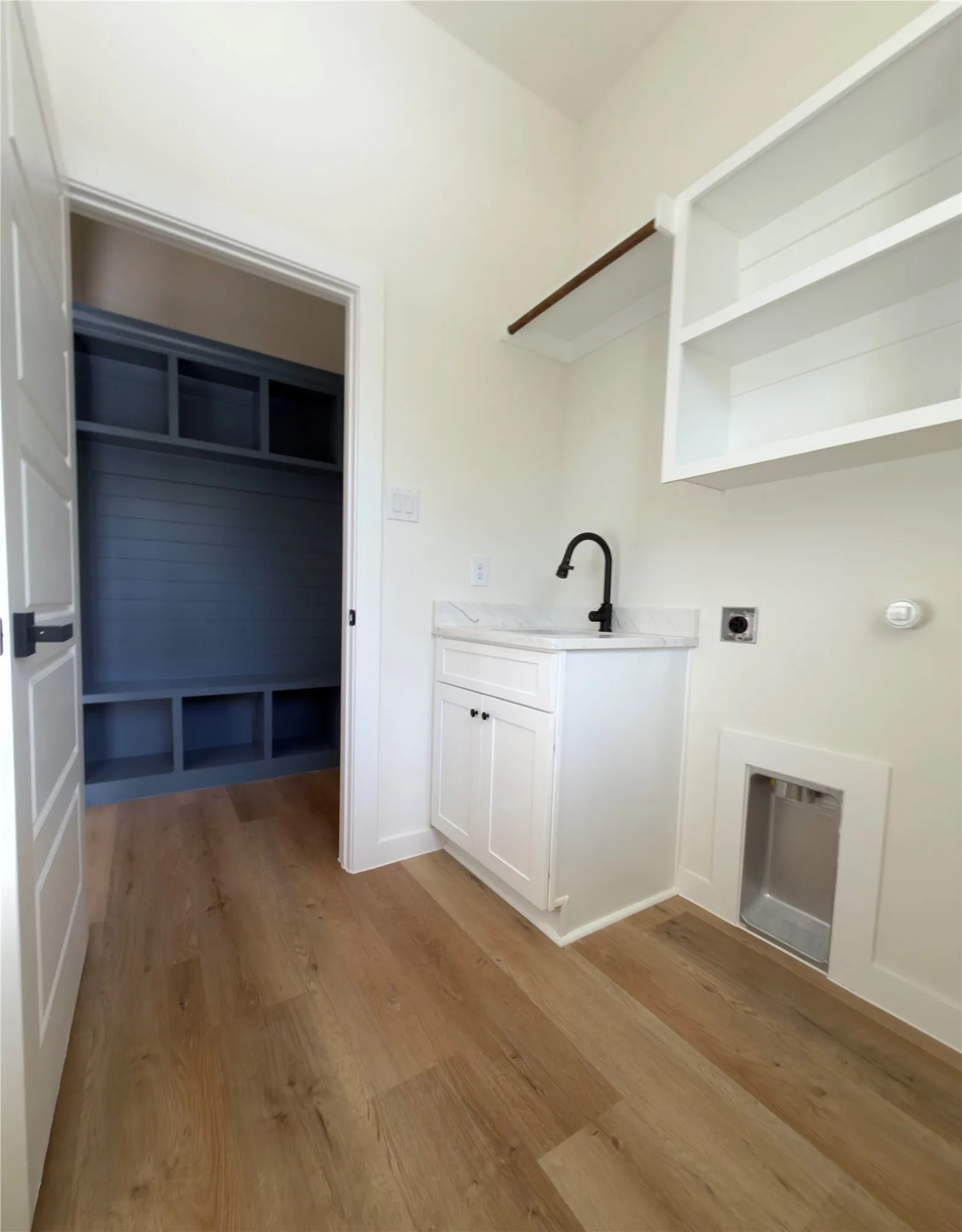 Laundry room with quartz top sink.