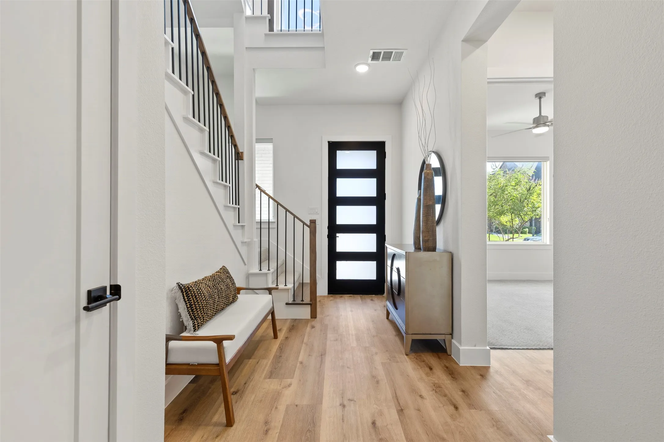 This home features newly installed luxury vinyl flooring throughout the entire first level, providing a modern, durable, and seamless look, complemented by a beautiful, high-quality upgraded wood front door that adds immediate curb appeal and elegance to the entrance.