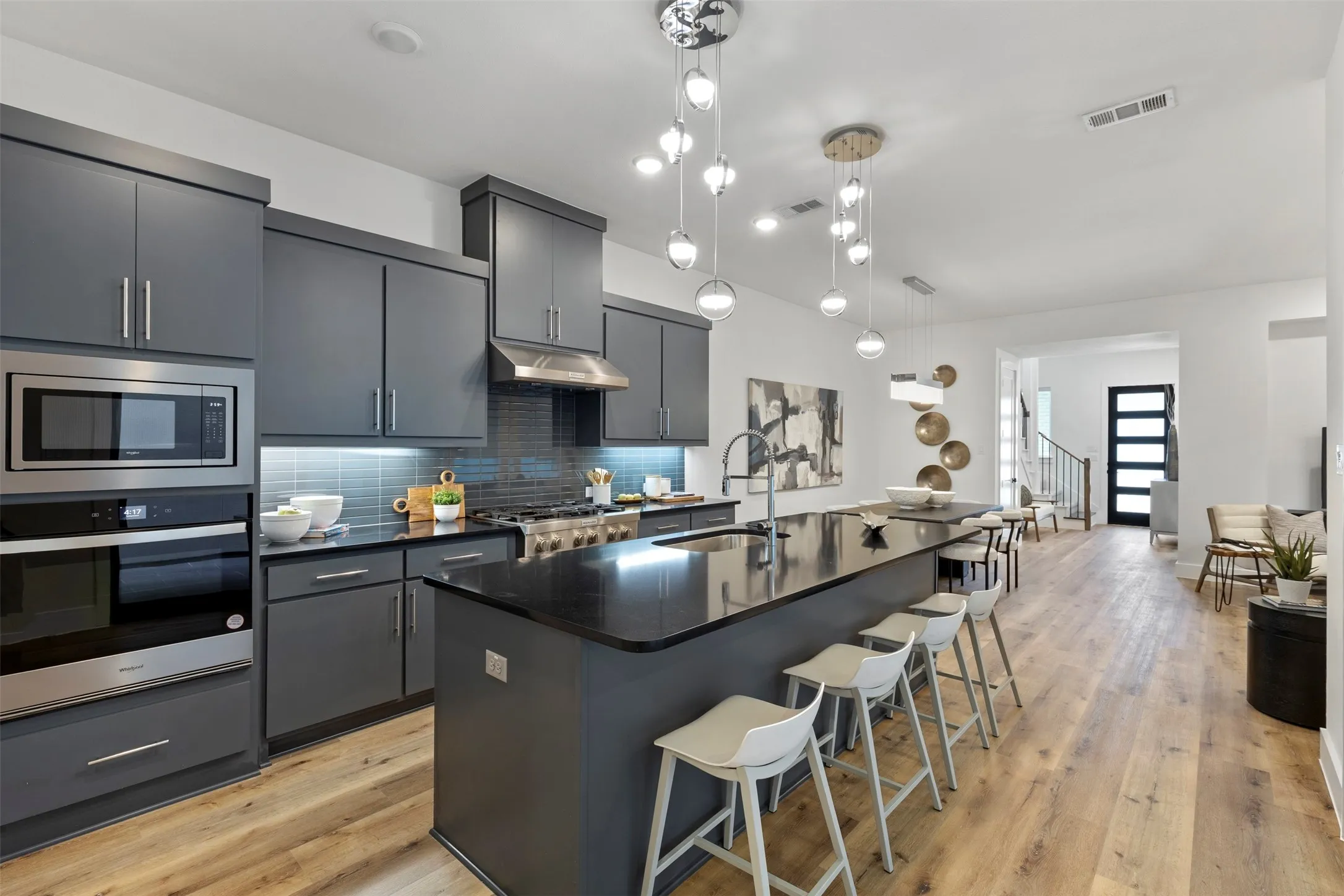 This expansive and inviting great room is perfectly designed for both effortless entertaining and comfortable daily living, featuring an open layout that seamlessly blends functionality with modern style to create the ultimate gathering space for family and guests alike.
