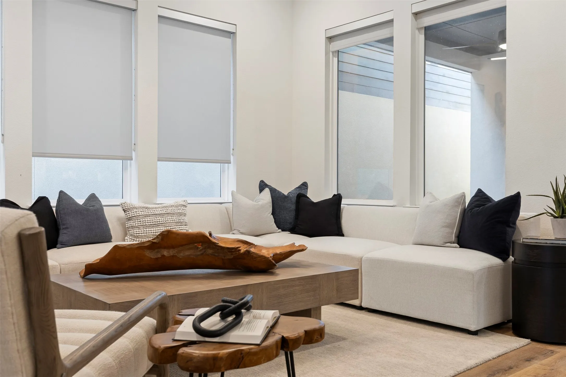 What a cozy living space, so inviting! This sun-drenched area features plush, comfortable seating arranged perfectly for relaxation or conversation, complemented by warm lighting and soft textures that make the room feel like a true sanctuary.