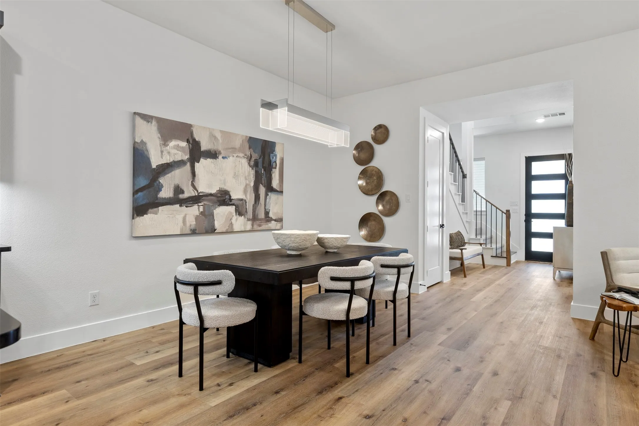 This home features extensively upgraded designer lighting fixtures installed throughout the entire interior, providing a modern and bright ambiance in every room.