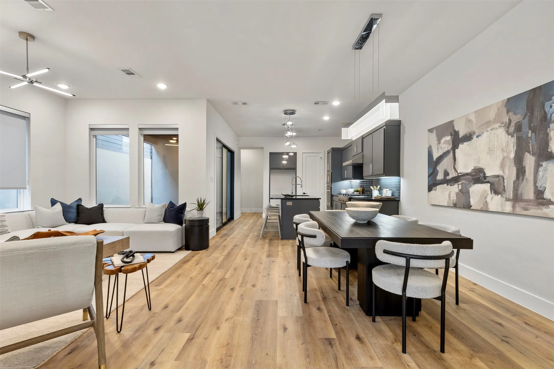 This home features a stunning open-concept floor plan that seamlessly connects the living space to a spacious, light-filled dining area.