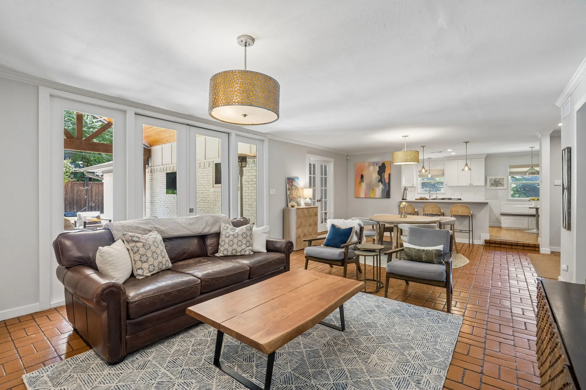 Brick-finish flooring, white wall paint, and recessed lighting