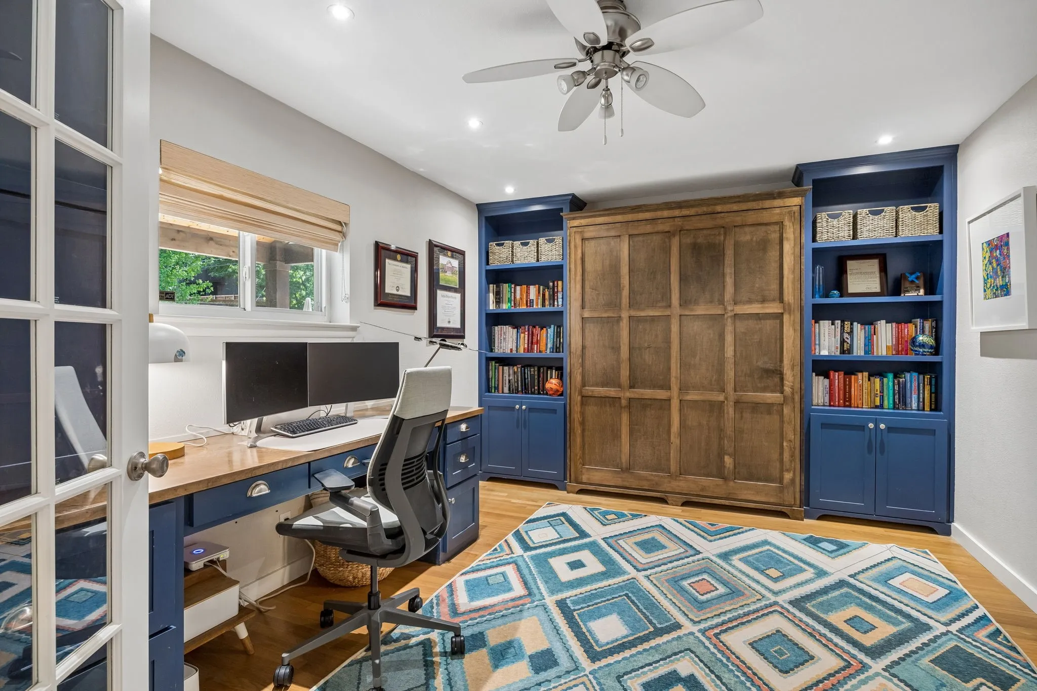 Built-in wood desk with integrated storage and wood-finish flooring