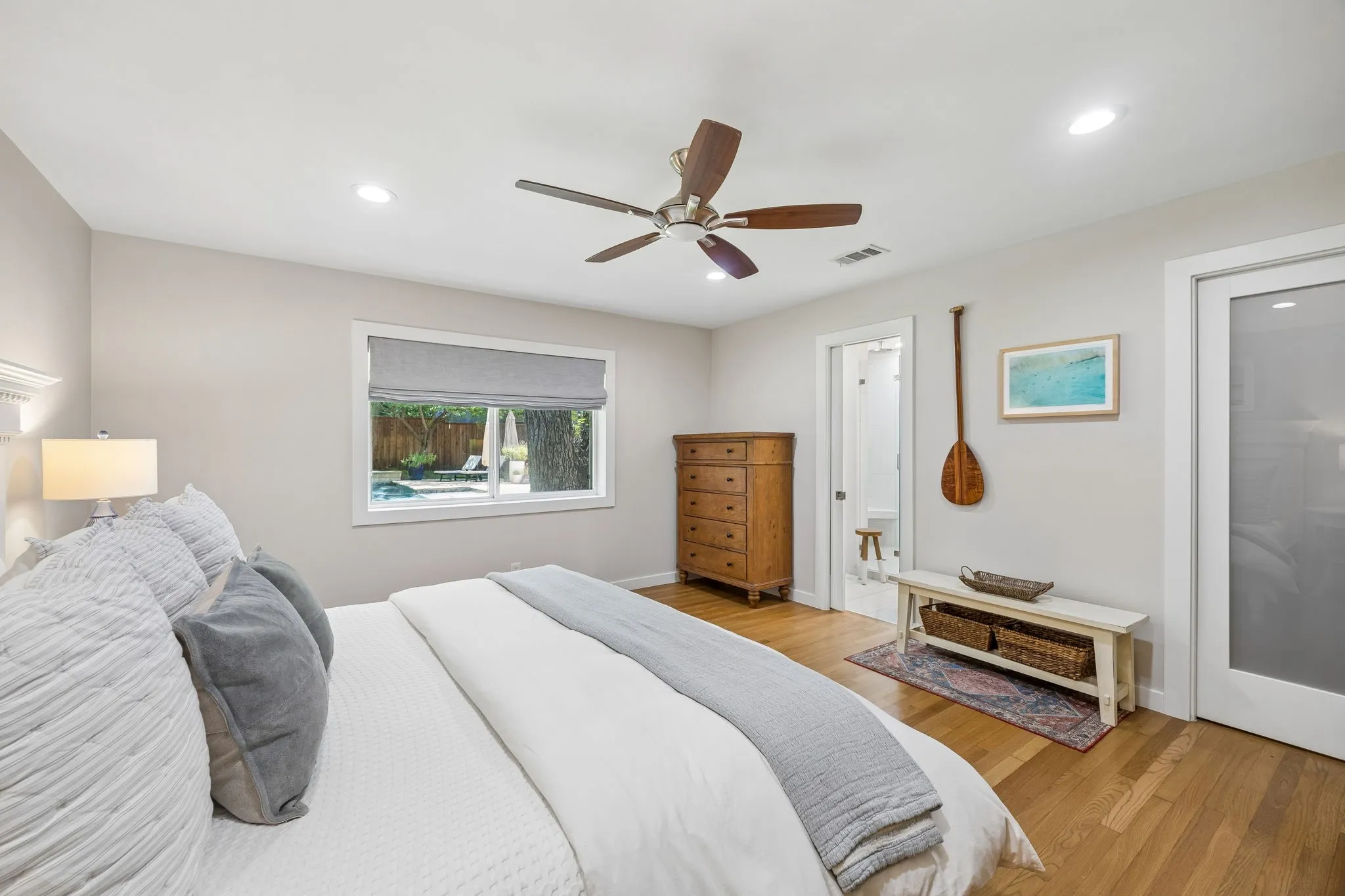 Wood-finish flooring, recessed lighting, wood ceiling fan, window with exterior pool visibility, and a frosted glass panel door