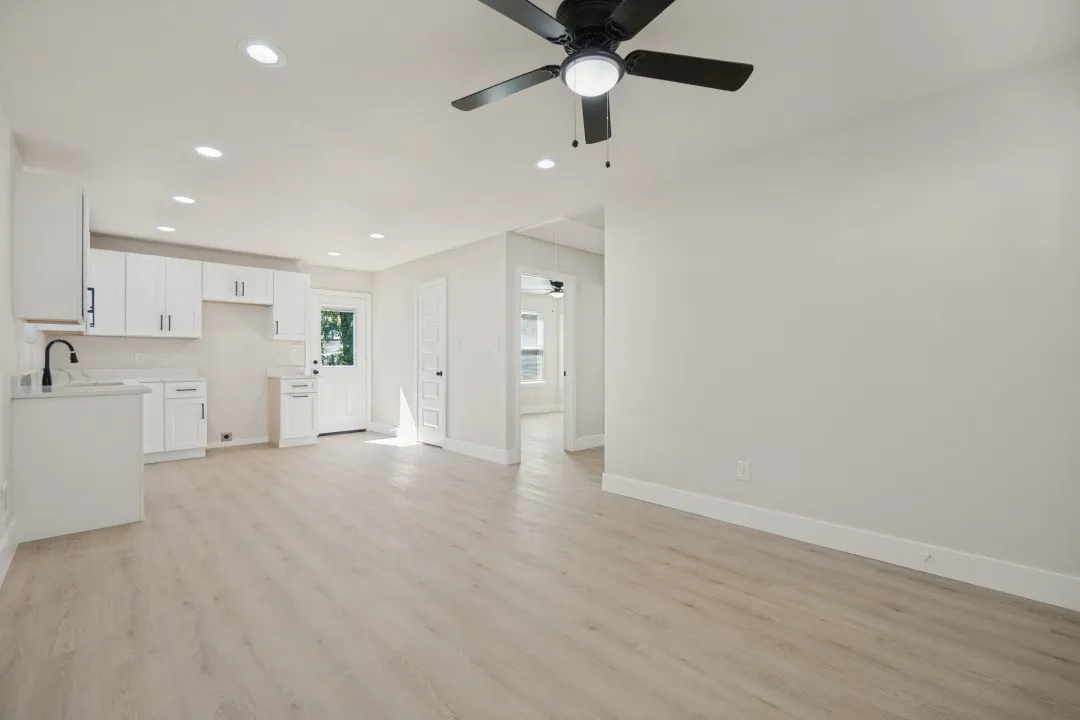 Recessed lighting, wood-finish flooring, and a ceiling fan with integrated lighting