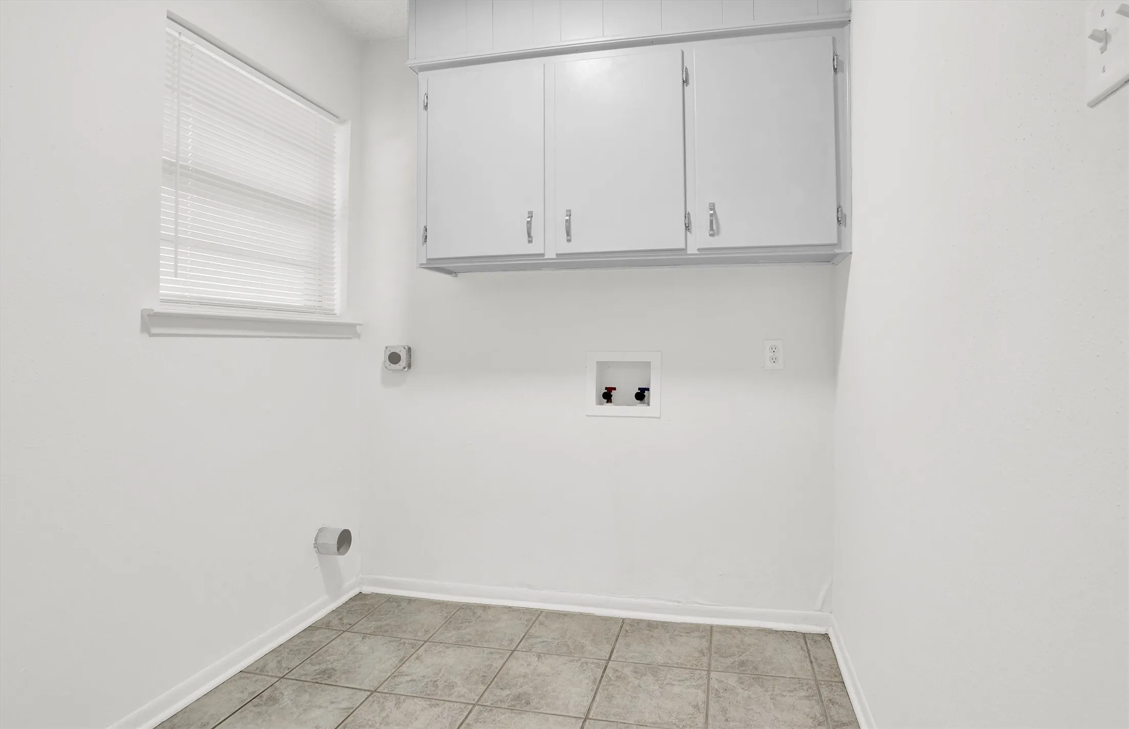 Spacious laundry with built-in cabinets