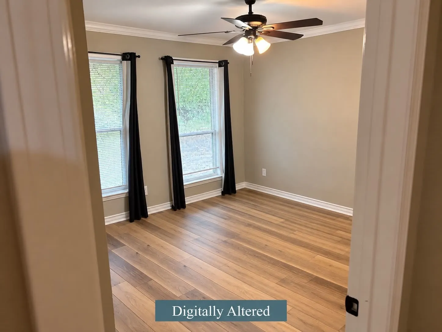 Wood-finish flooring, crown molding, double windows, ceiling fan with integrated lighting-digitally altered to remove furniture