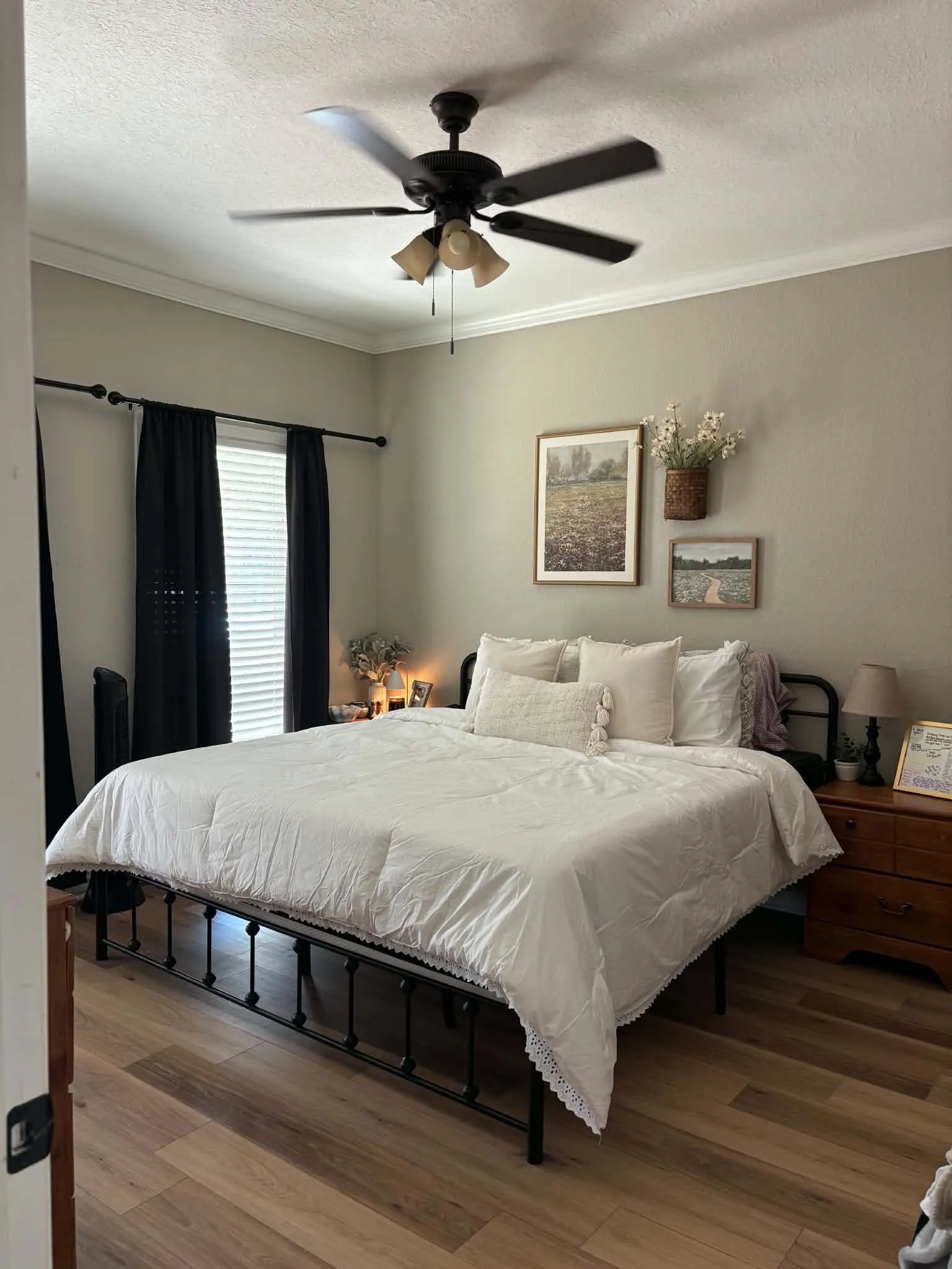 Wood-finish flooring, ceiling fan with light fixture, window with blinds, and crown molding