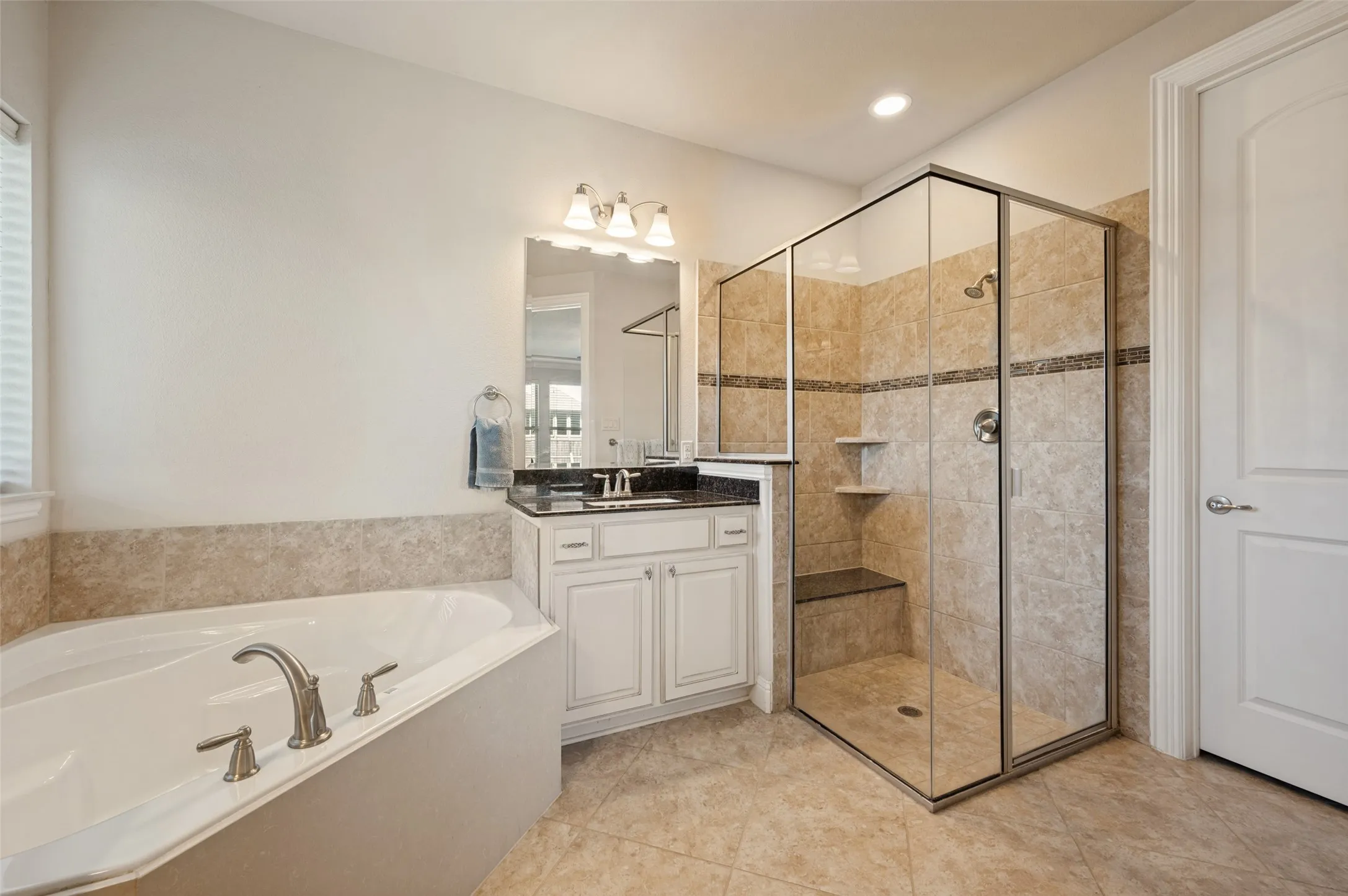 Corner soaking tub with deck-mounted faucet