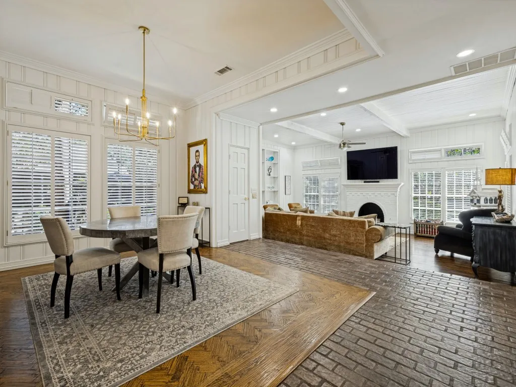 Open-concept living area with white paneled walls and a coffered ceiling