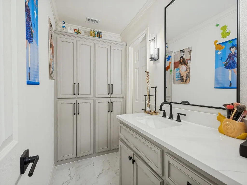 Vanity with an integrated rectangular sink, white countertop, and dark-finish faucet