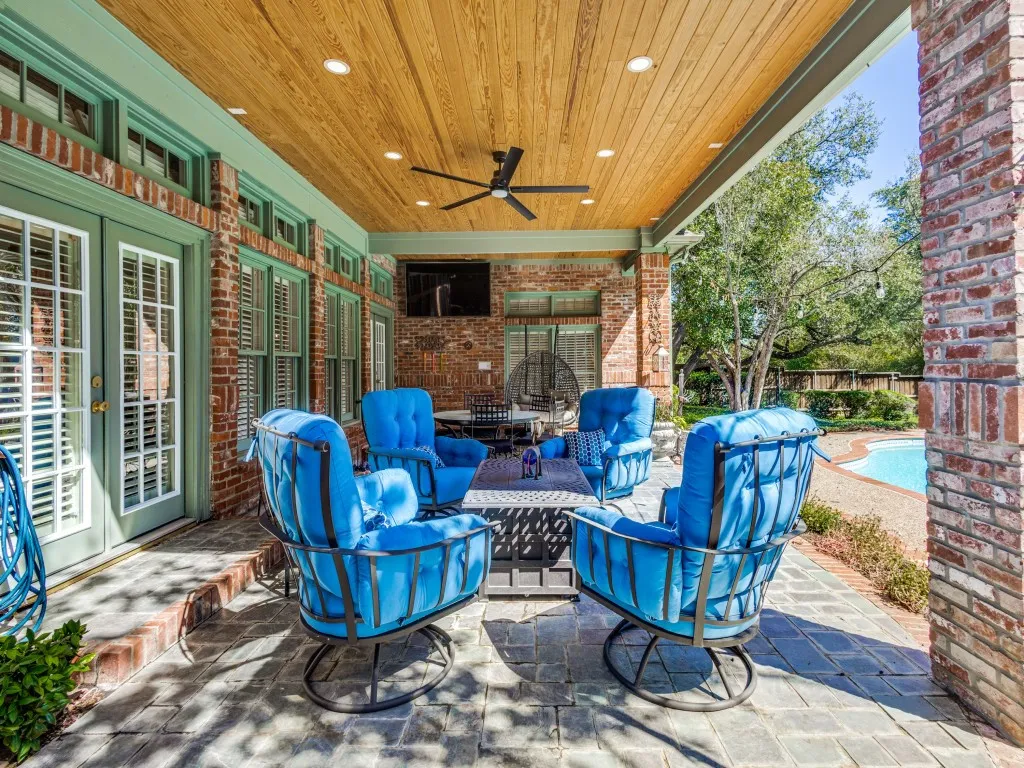 Covered patio with a wood-plank ceiling, recessed lighting, and a ceiling fan