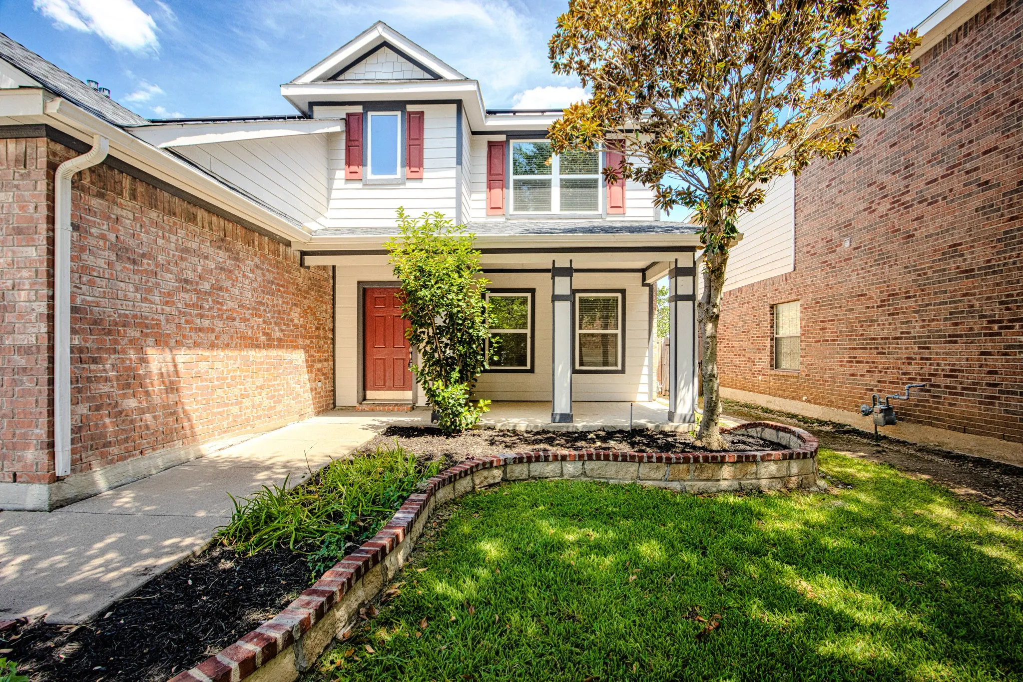 Brick and siding exterior with a covered porch