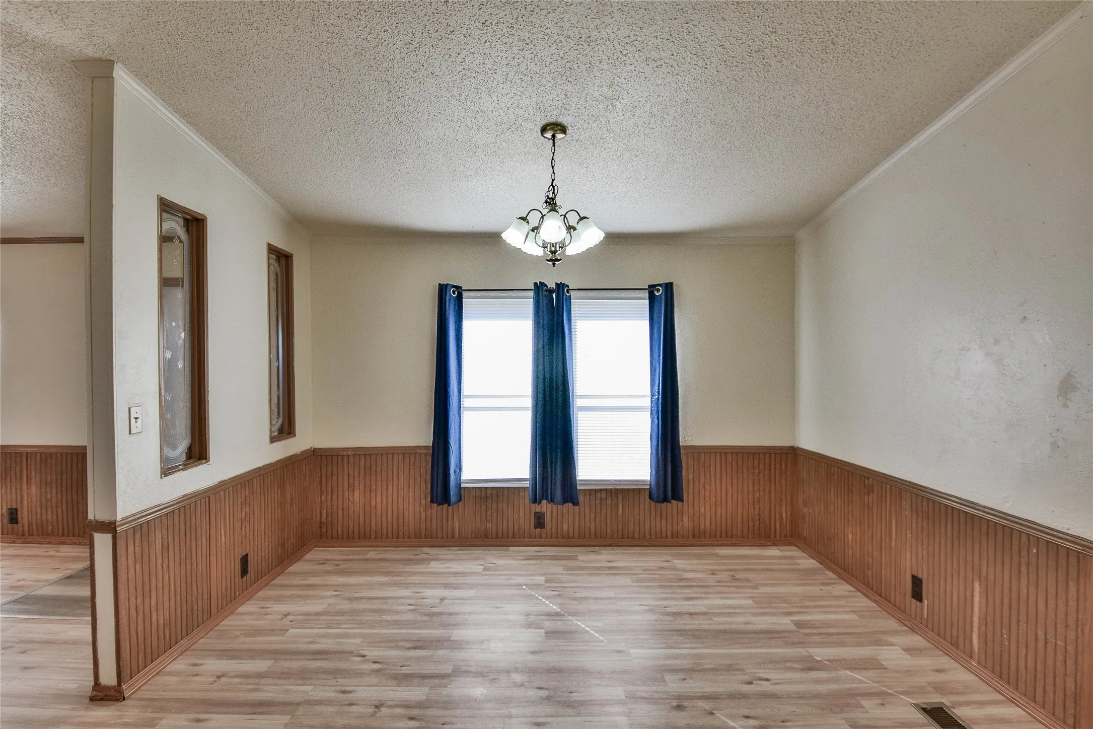 Wood-look vinyl  flooring with beadboard wainscoting and crown molding