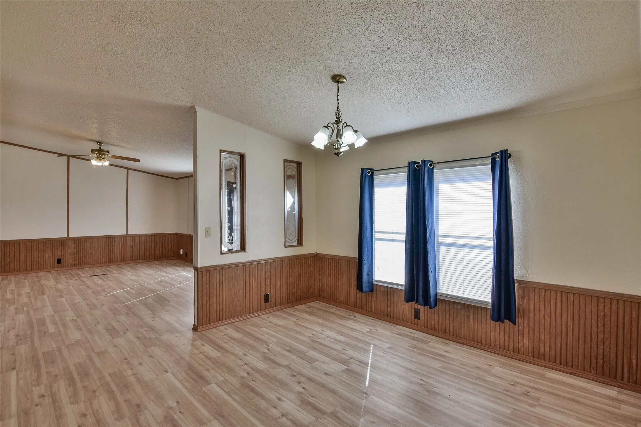 Wood-finish flooring throughout, featuring beadboard paneling and overhead lighting