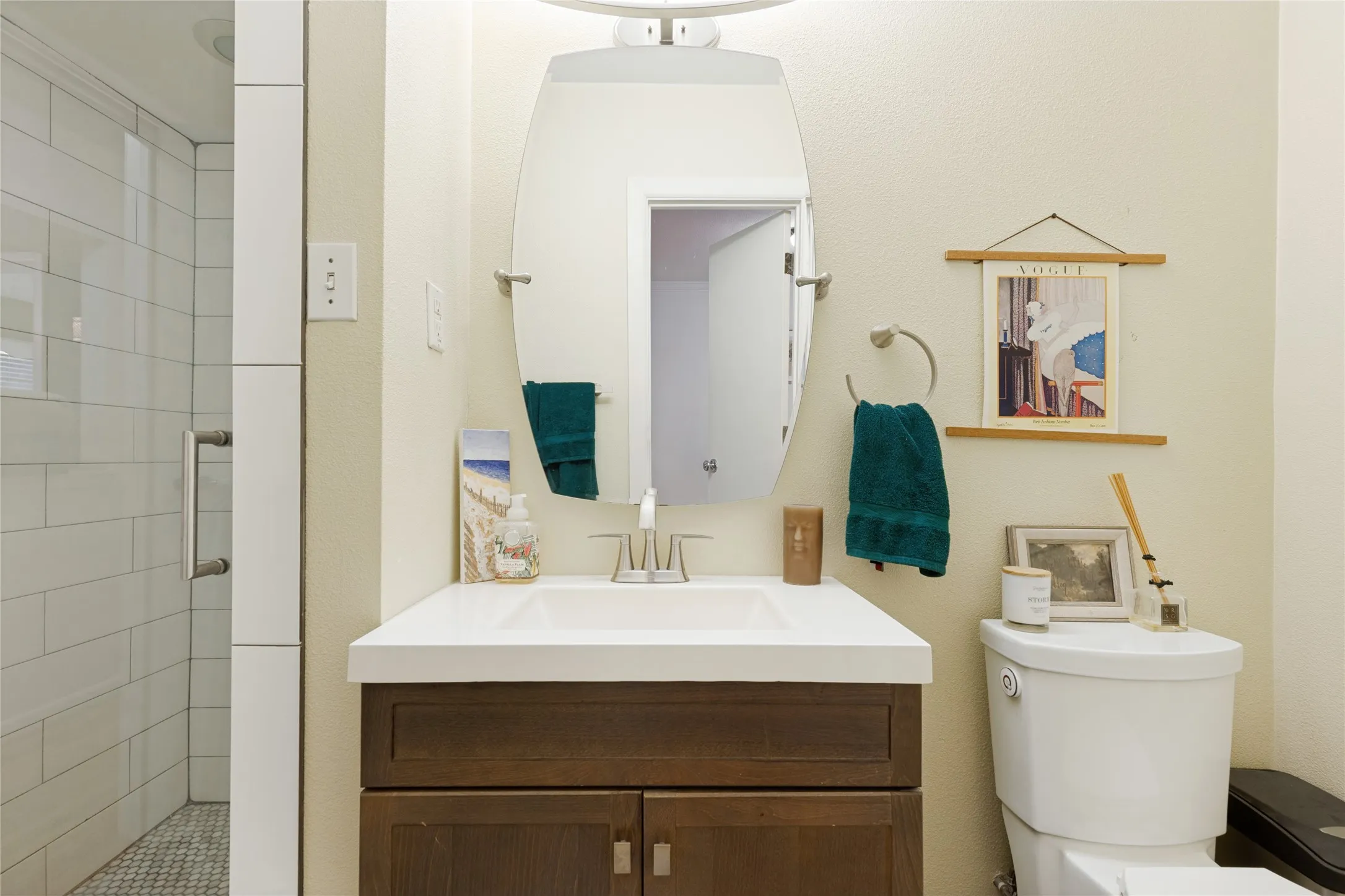 The updated Guest Bath provides a fresh counterpoint to the home’s preserved vintage details.