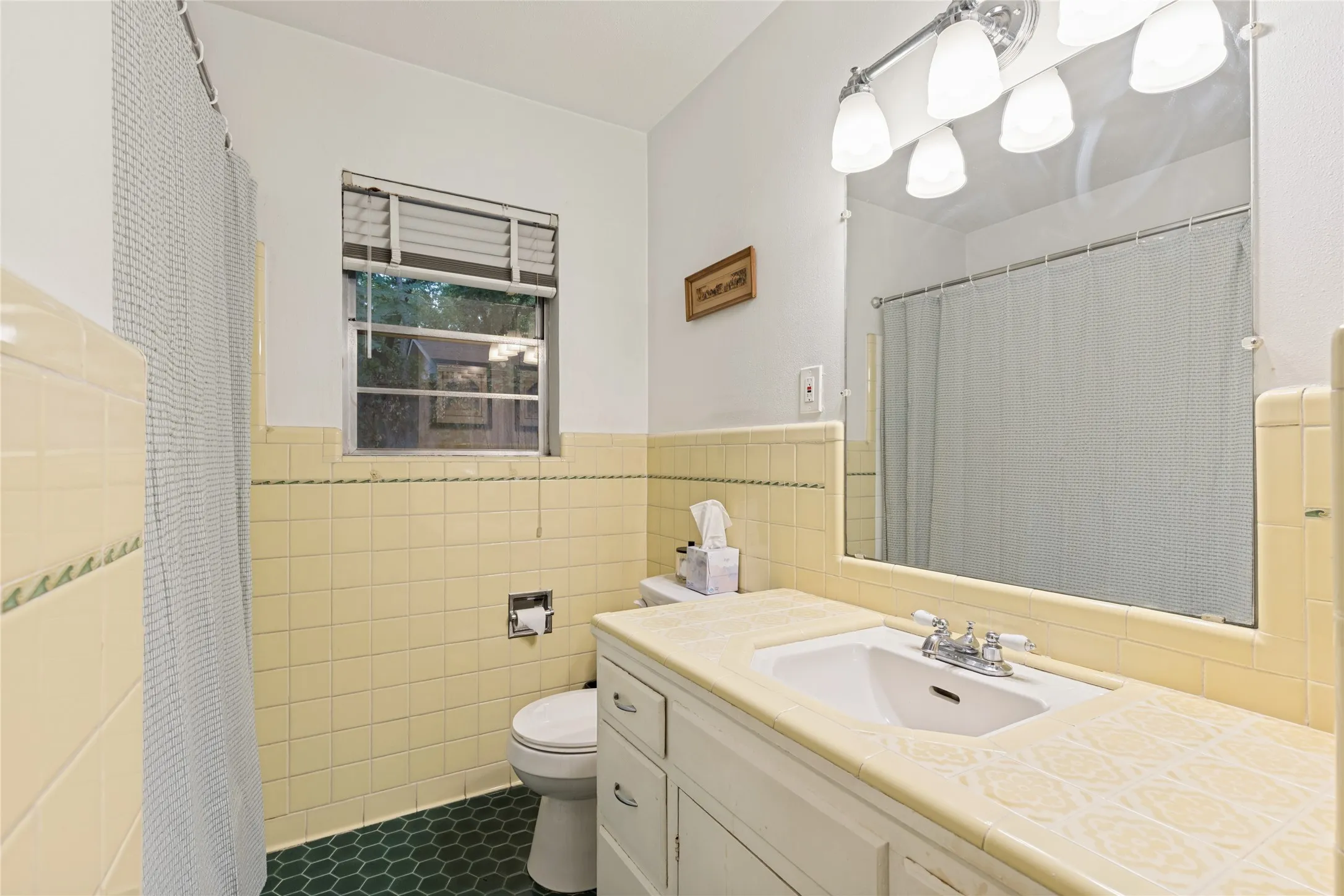 The Primary Bath is pure vintage joy, with fabulous original tile and wonderfully intact period character.