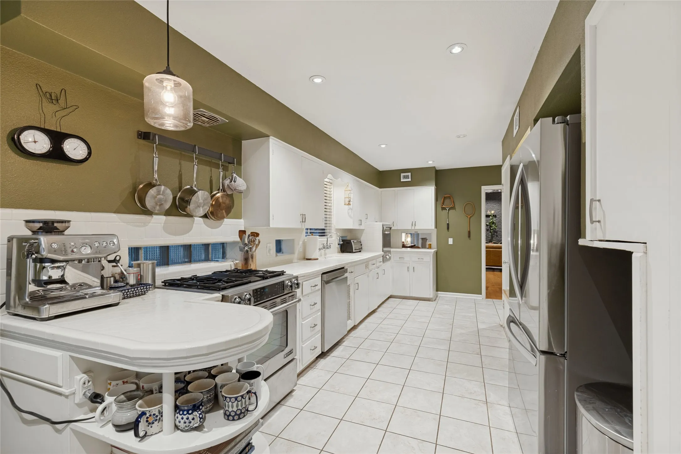 The thoughtful cutout beside the refrigerator is original millwork, one of the home’s many distinctive details.