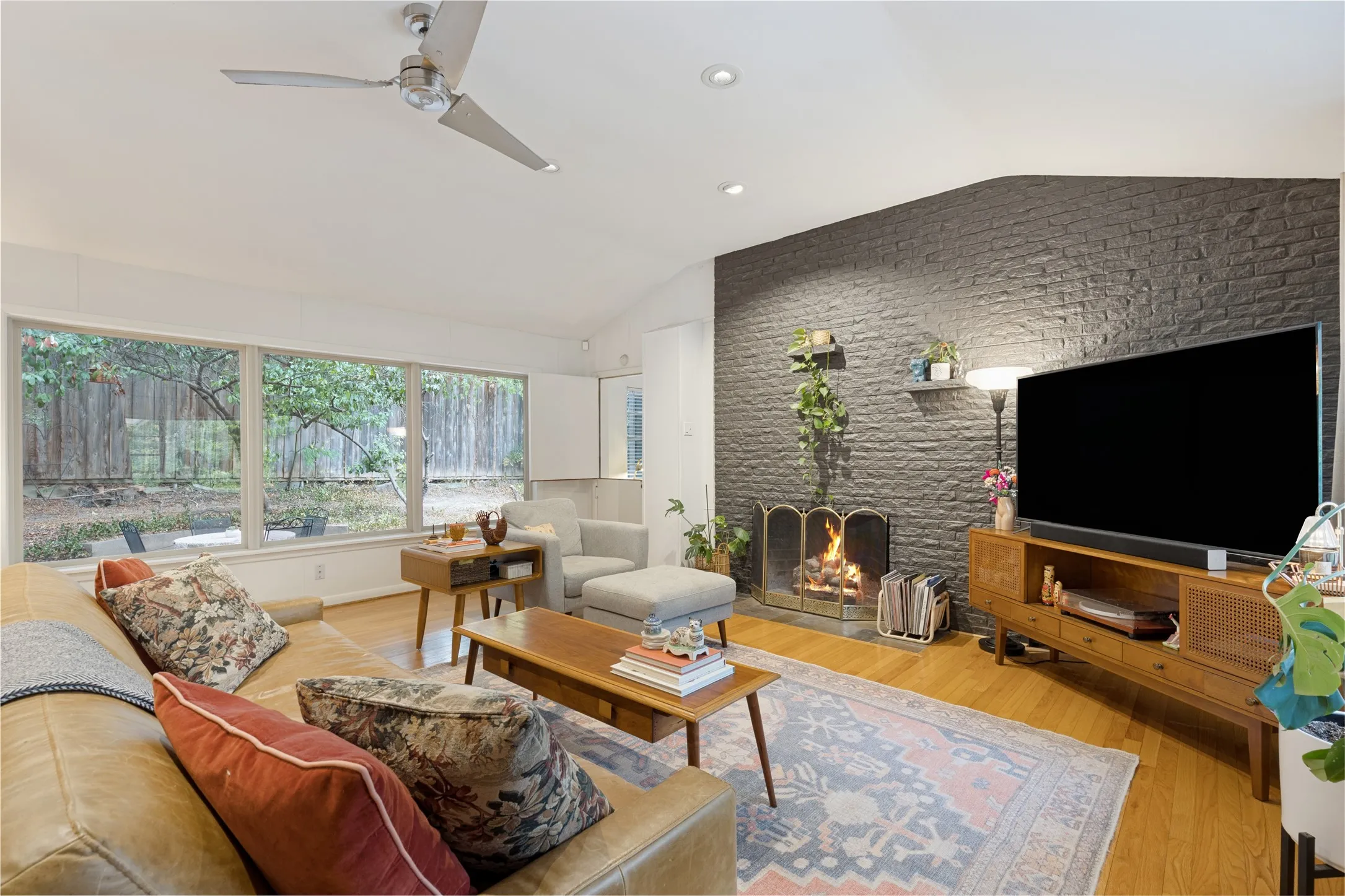 Generous windows connect the Living Room to the surrounding trees and changing light.