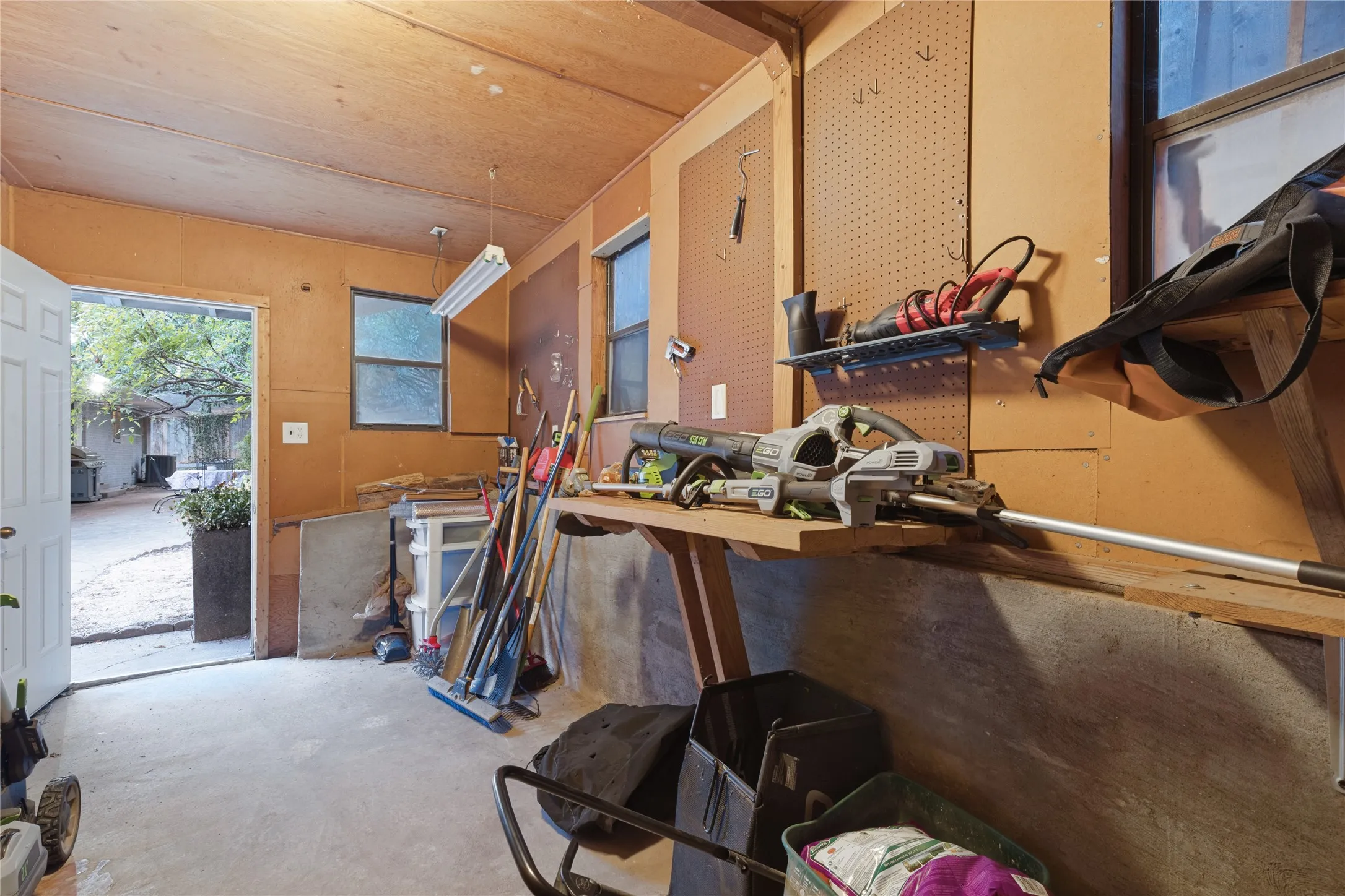 Tucked behind the Garage, the large windowed Workshop has its own entrance and abundant potential for a studio, maker space or serious projects.