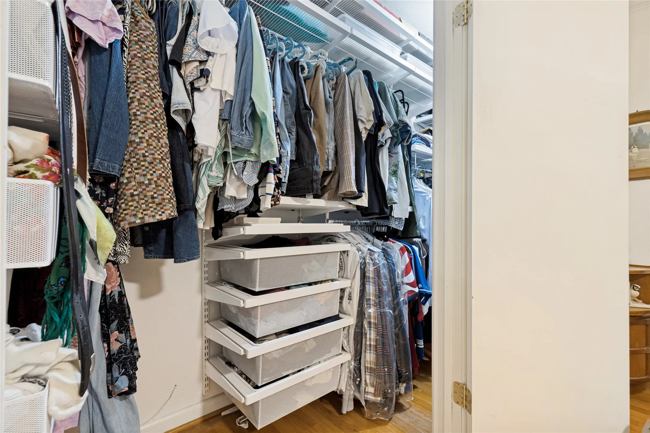 The Primary Bedroom closet is outfitted with a highly functional Elfa shelving system.
