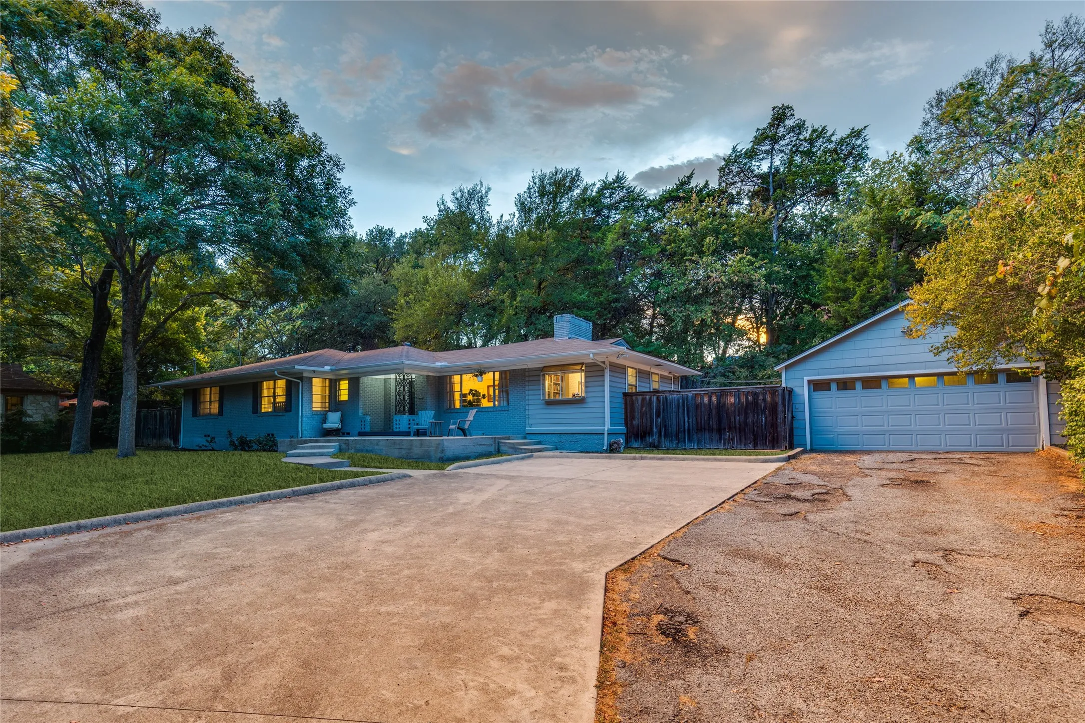 Low-slung architecture settles naturally beneath a canopy of mature trees.