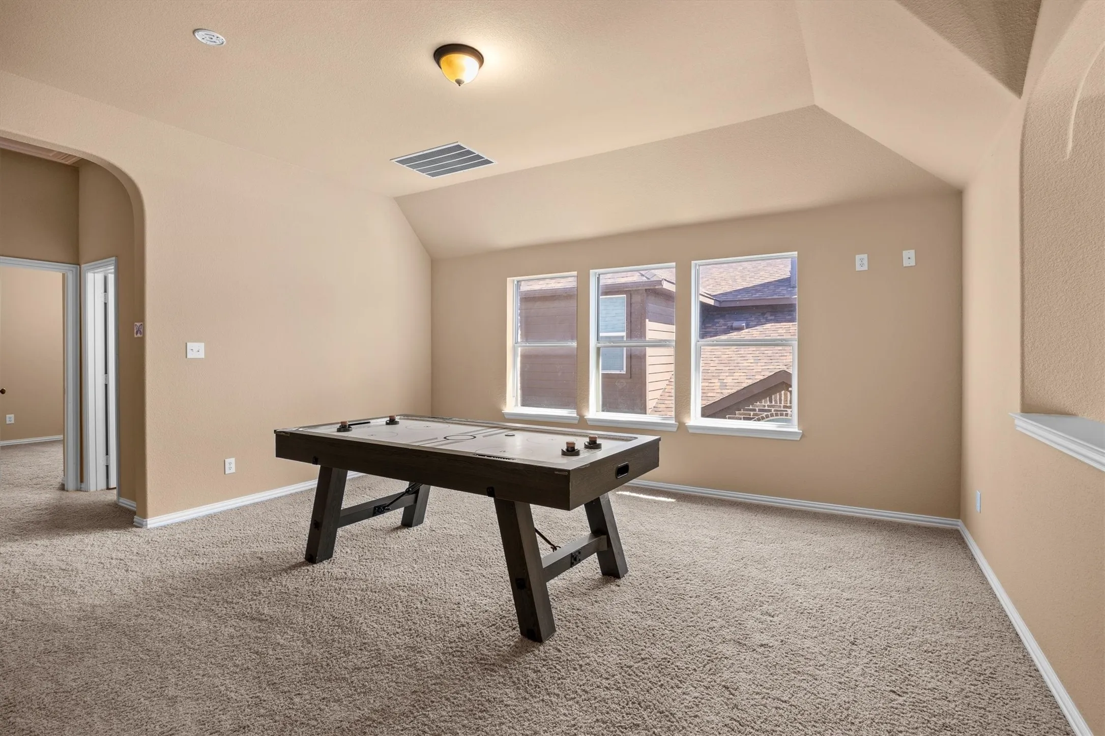 This bright upstairs game room offers plenty of space for friendly competition!