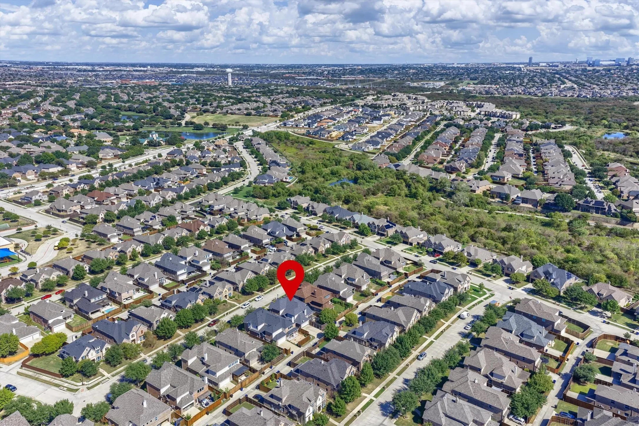 This aerial view shows the home’s position along the street, with garage access at the rear.