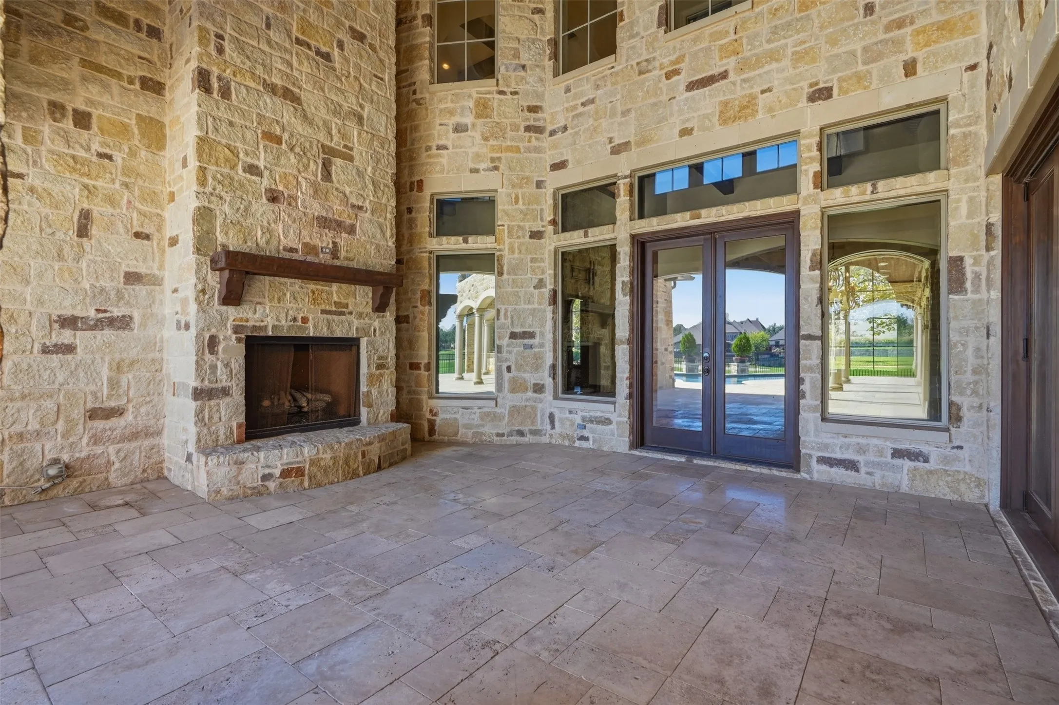 View of covered patio with gas fireplace, facing the living room