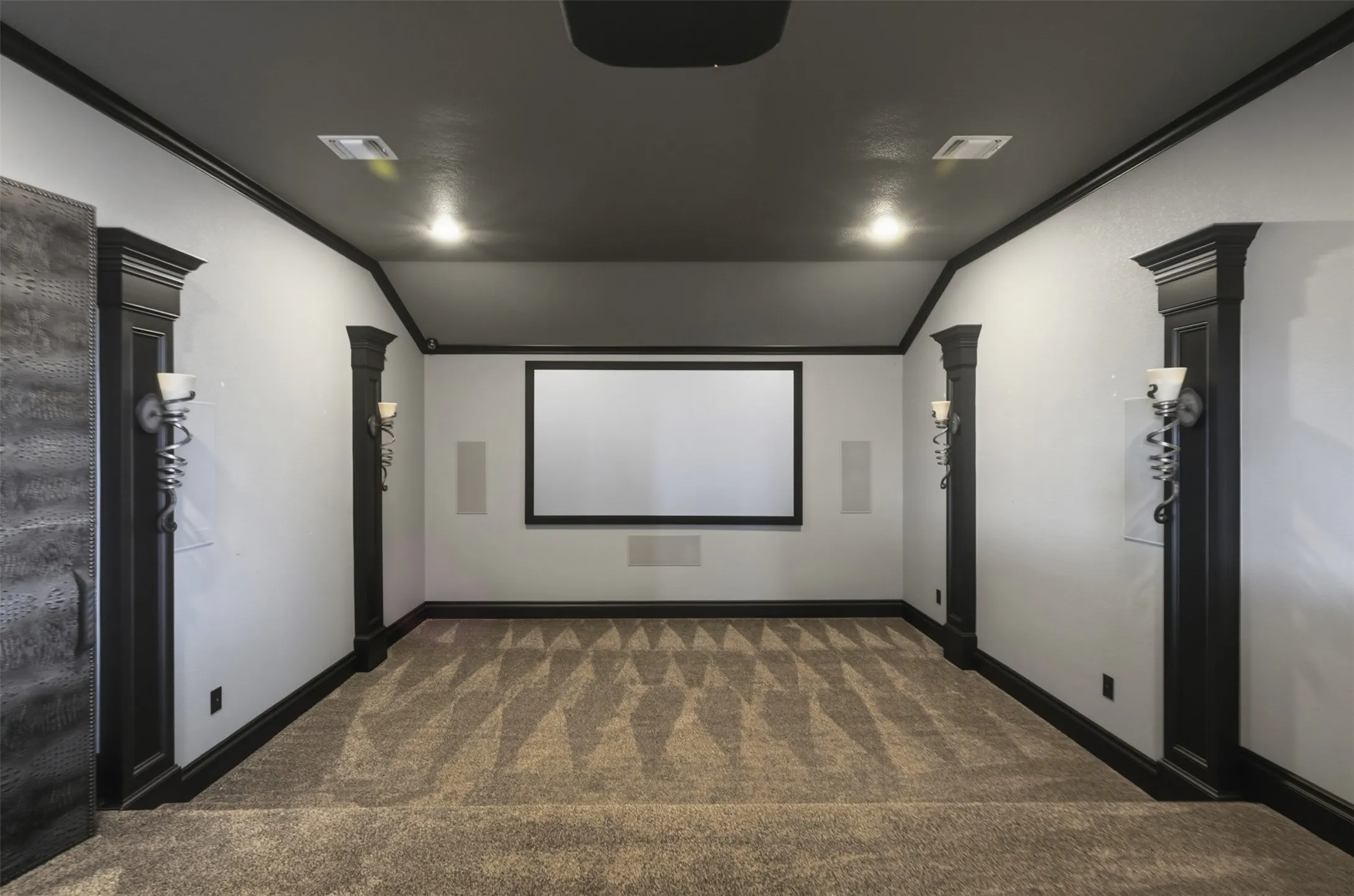 Enter the media room through custom faux alligator doors and settle in for a true cinema experience, complete with a 130" Dimond projector screen and a 4K projector.