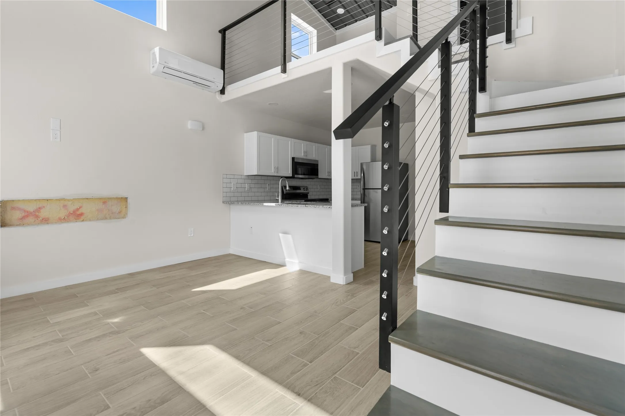 Kitchen featuring white cabinetry, subway tile backsplash, and stainless steel appliances