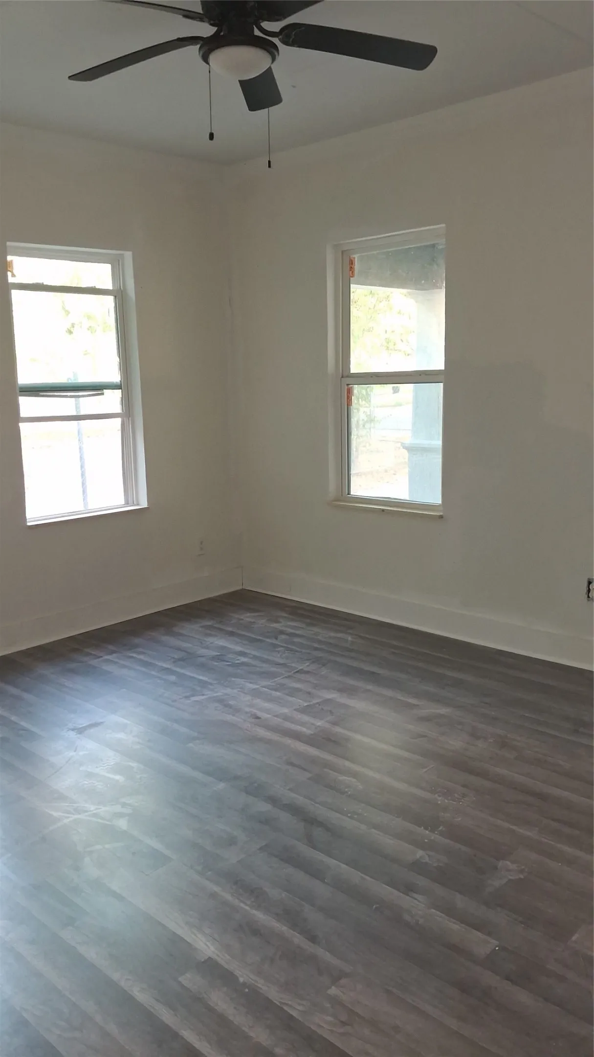 Recessed lighting, wood-finish flooring, and a ceiling fan