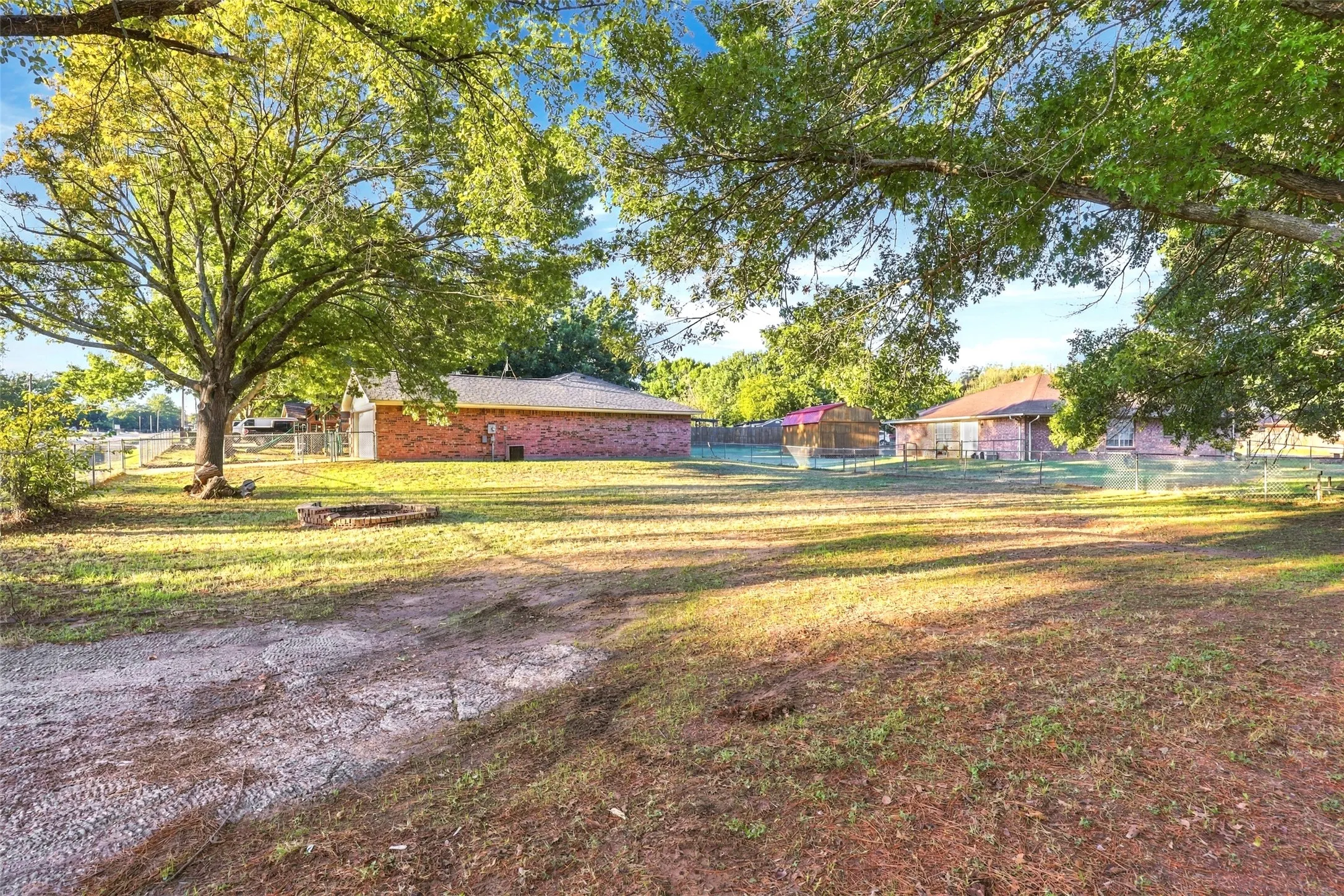 Backyard – Expansive double lot with mature shade trees and plenty of open outdoor space.