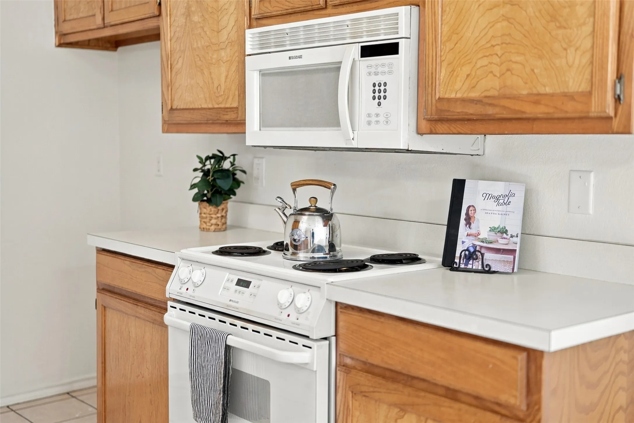 Kitchen – Electric range, built-in microwave, and ample countertop and cabinet space.