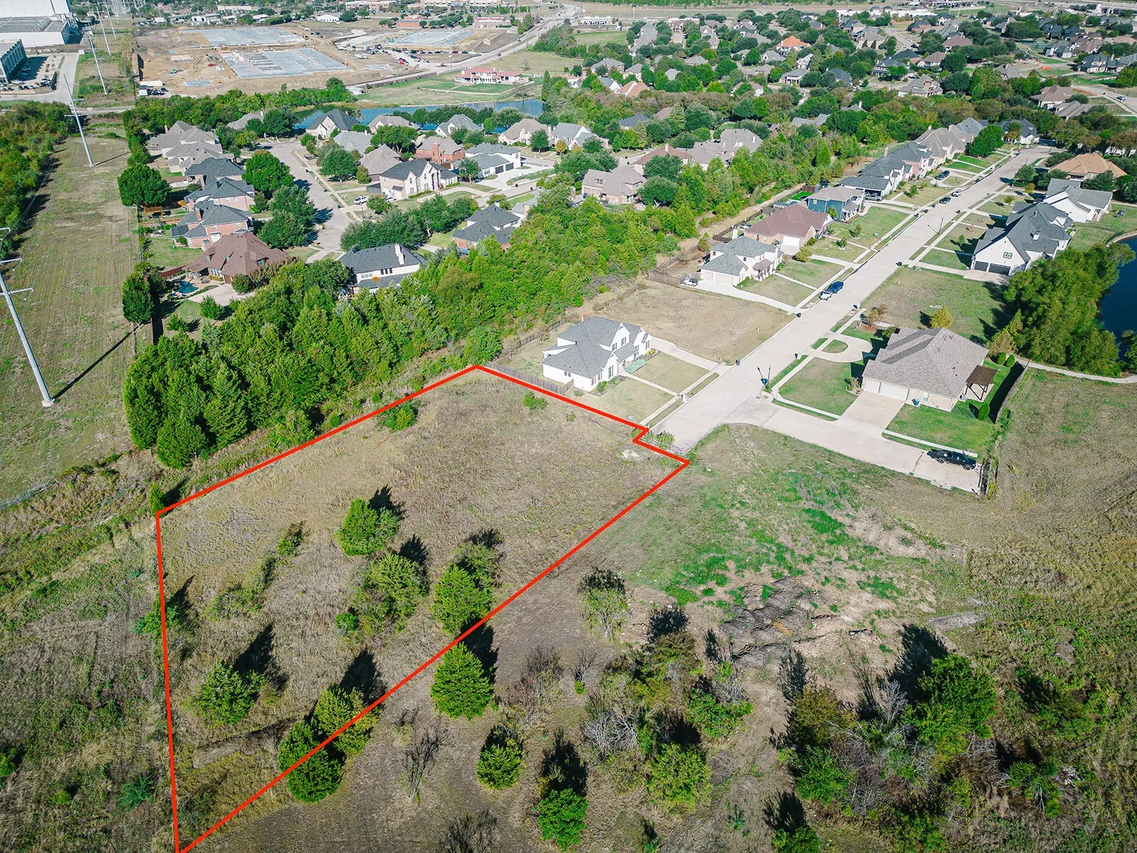 Expansive undeveloped land parcel featuring varied terrain and mature trees