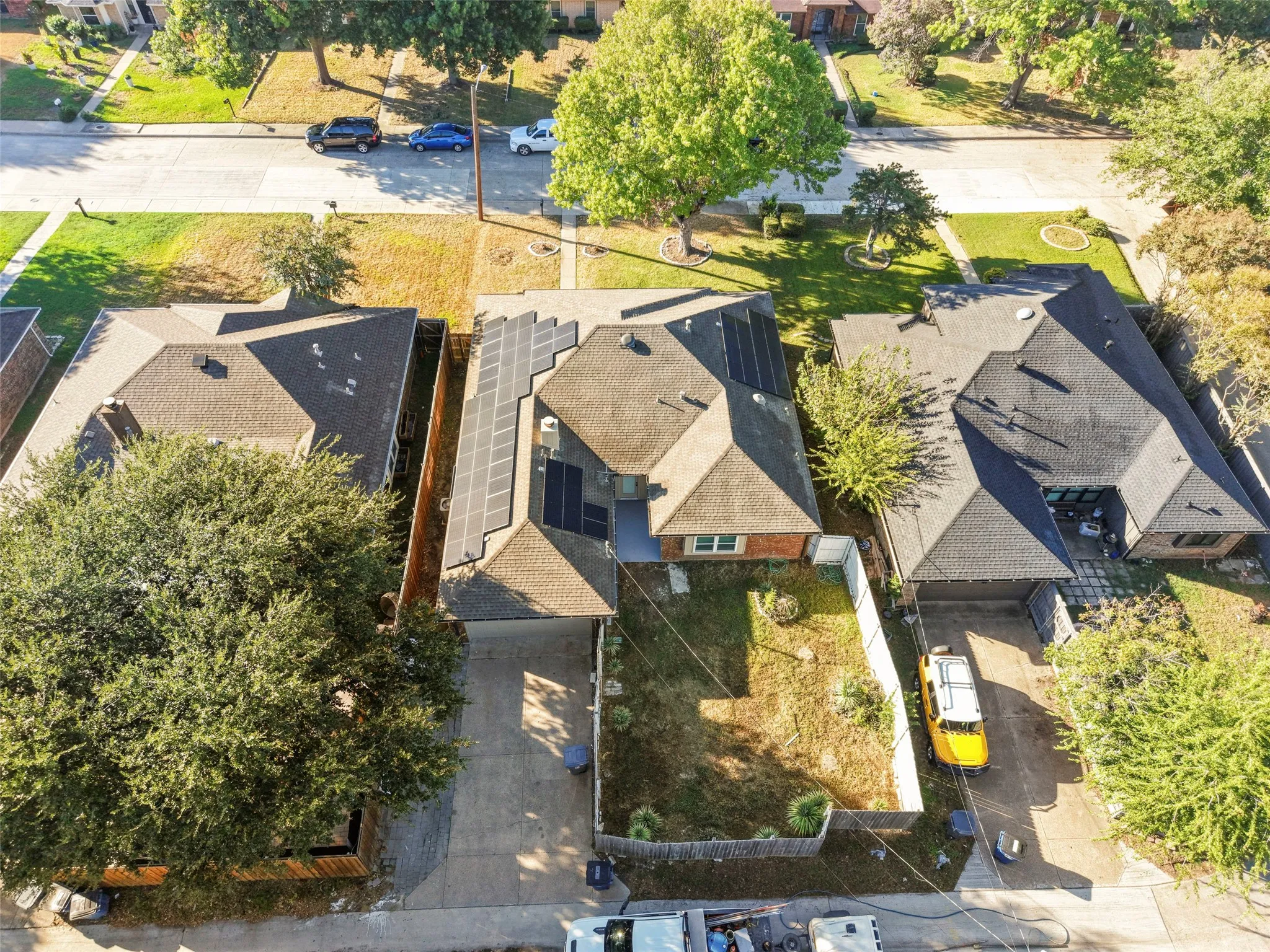 Residential property featuring a pitched roof, attached garage, and a concrete driveway