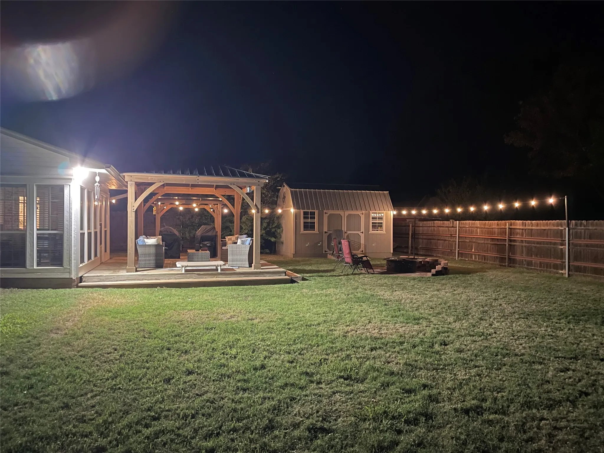 Expansive grass lawn with a wooden privacy fence